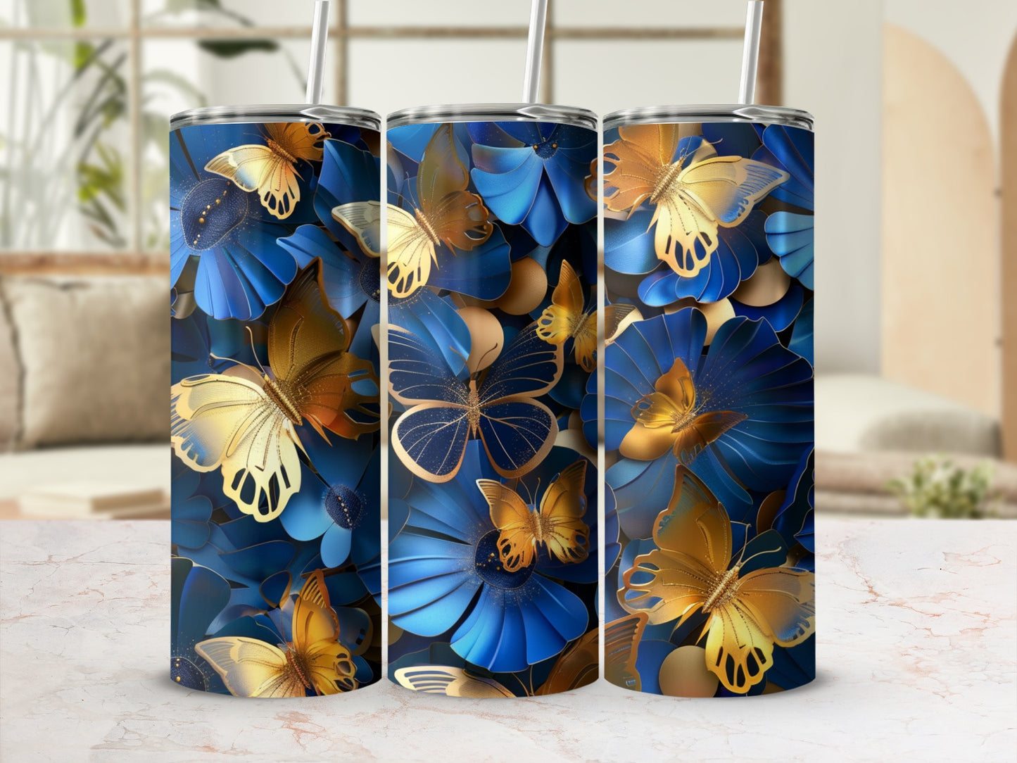 Gold butterflies and blue flowers on a patterned tumbler with straw.