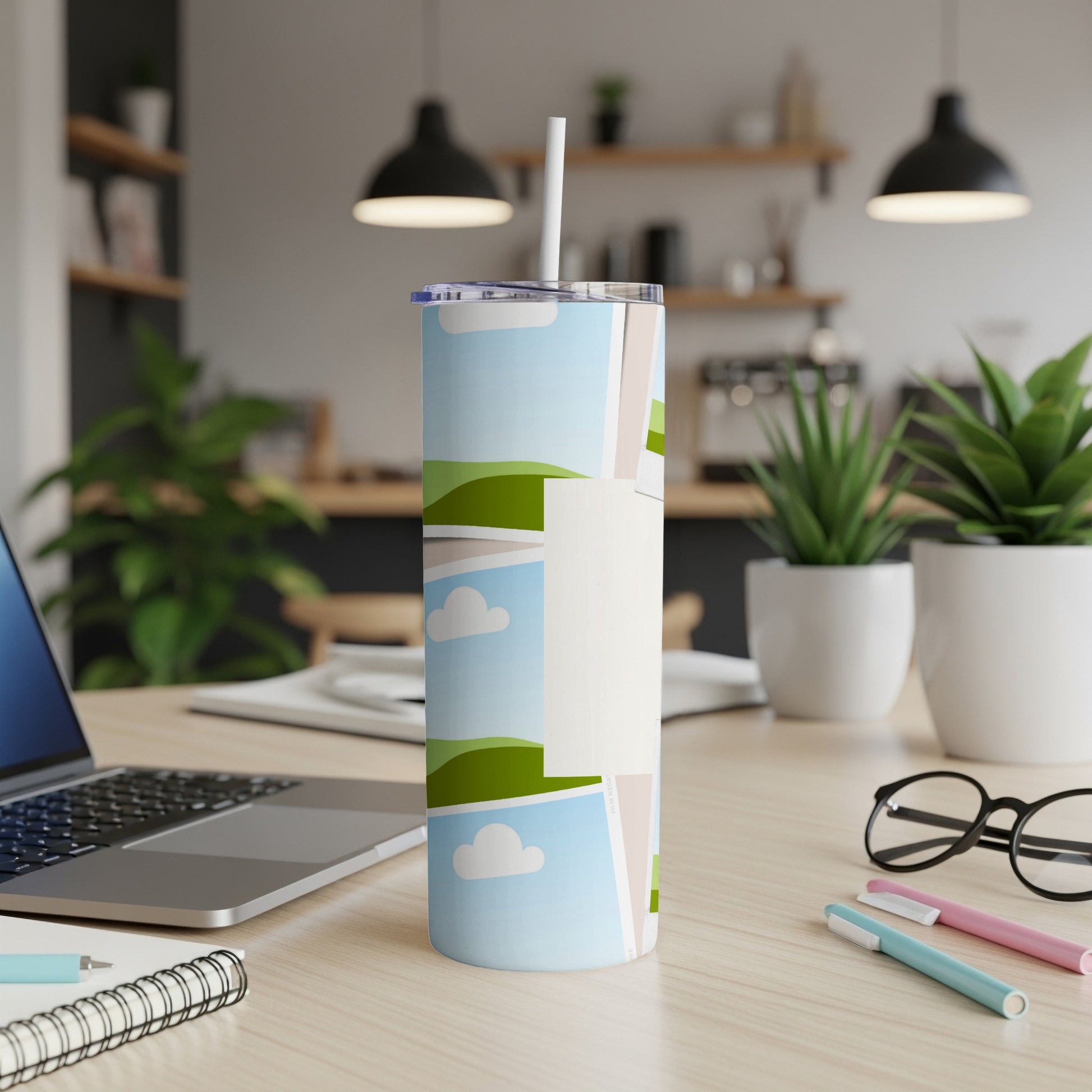 Tall tumbler with a straw and a design of framed nature photos.