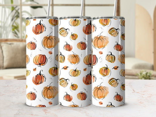 Watercolor pumpkins pattern on three tumblers with straws.