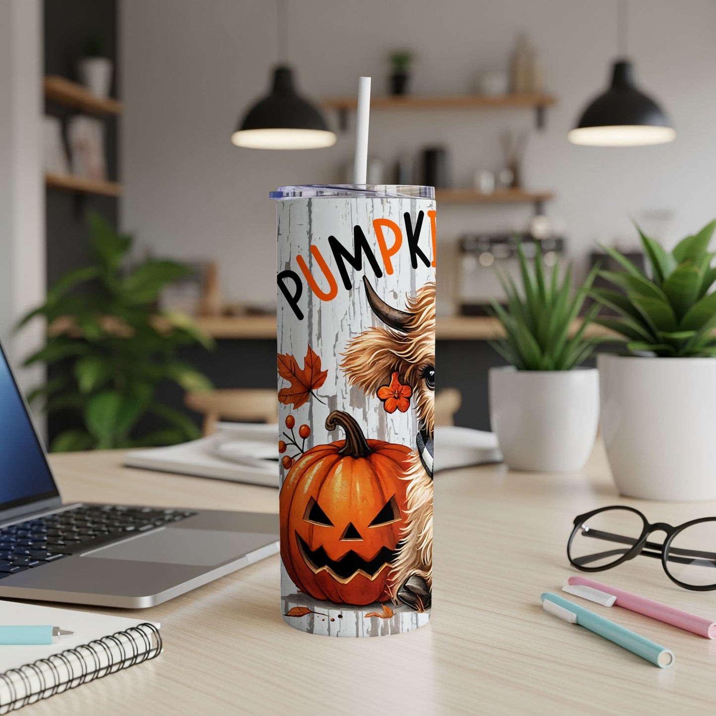 Tumbler with a Halloween design featuring a Highland cow, pumpkin, and the word "PUMPKIN".
