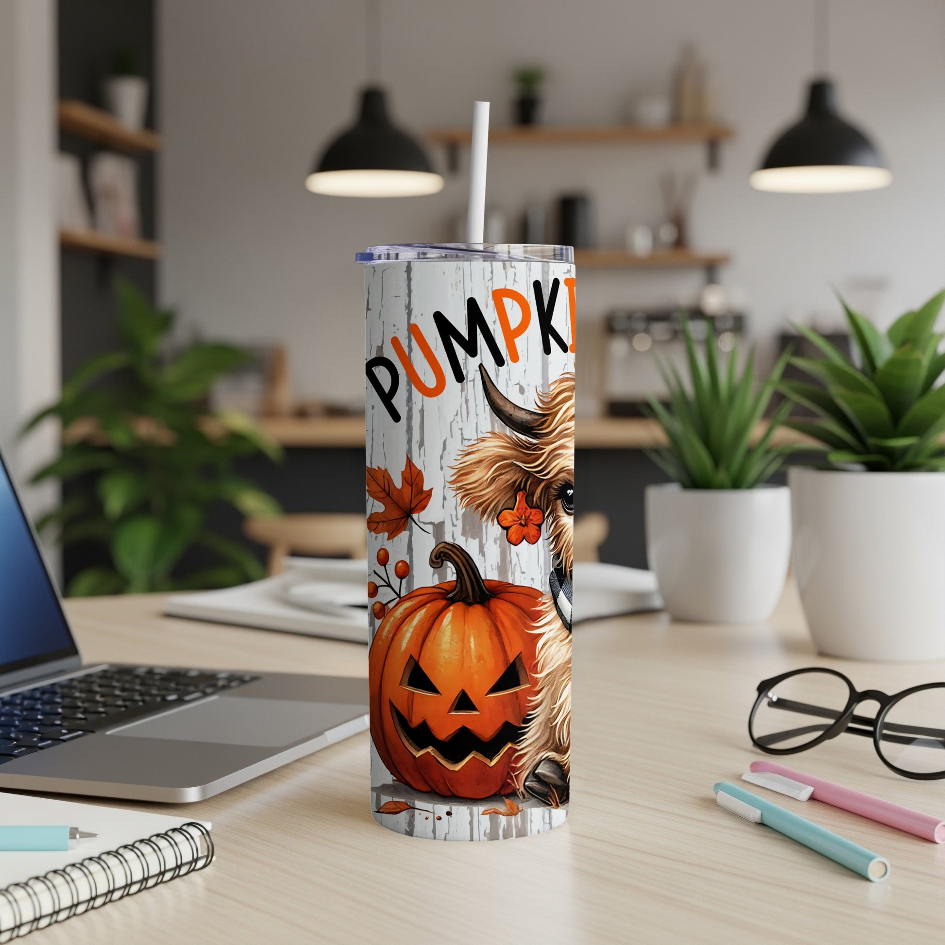 Tumbler with a Halloween design featuring a Highland cow, pumpkin, and the word "PUMPKIN".