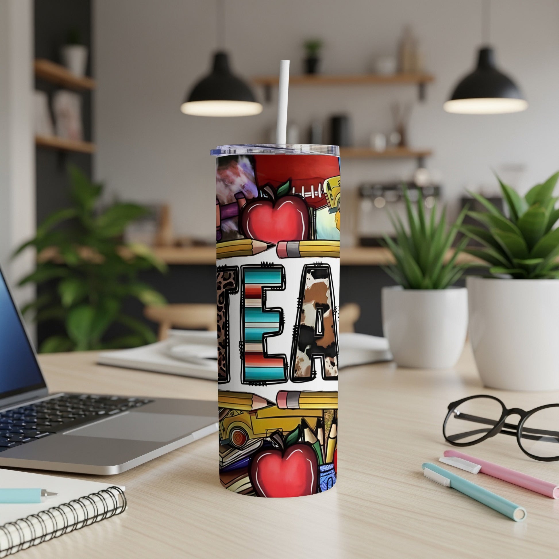Tumbler with "TEAM" text, apples, pencils, and cow print.