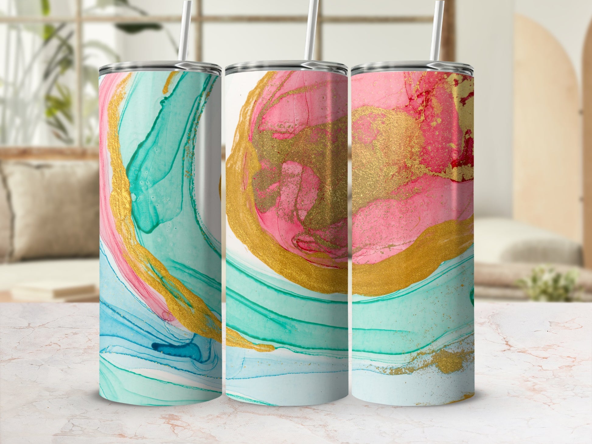 Three tumblers with abstract pink, gold, and teal marbling patterns.