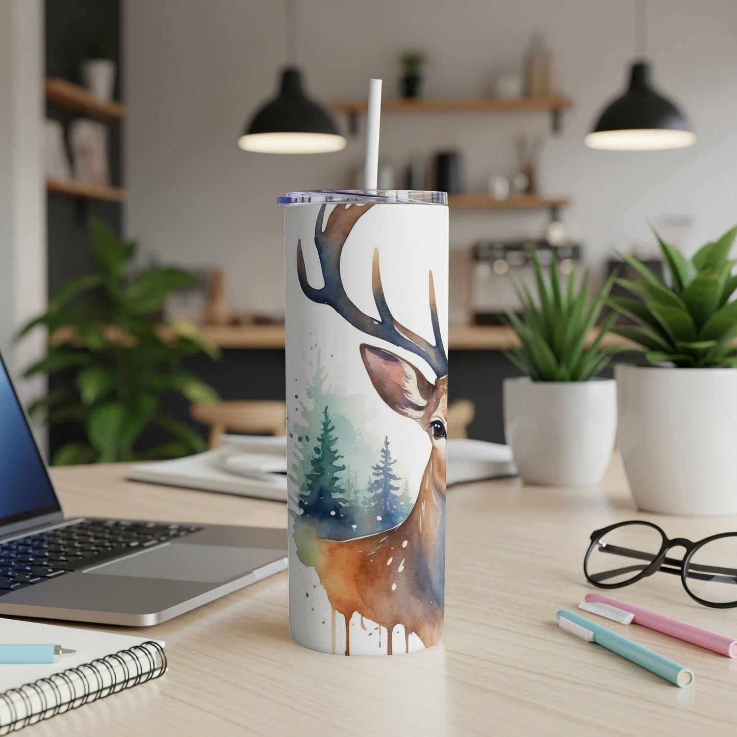 White tumbler with watercolor deer and forest design.