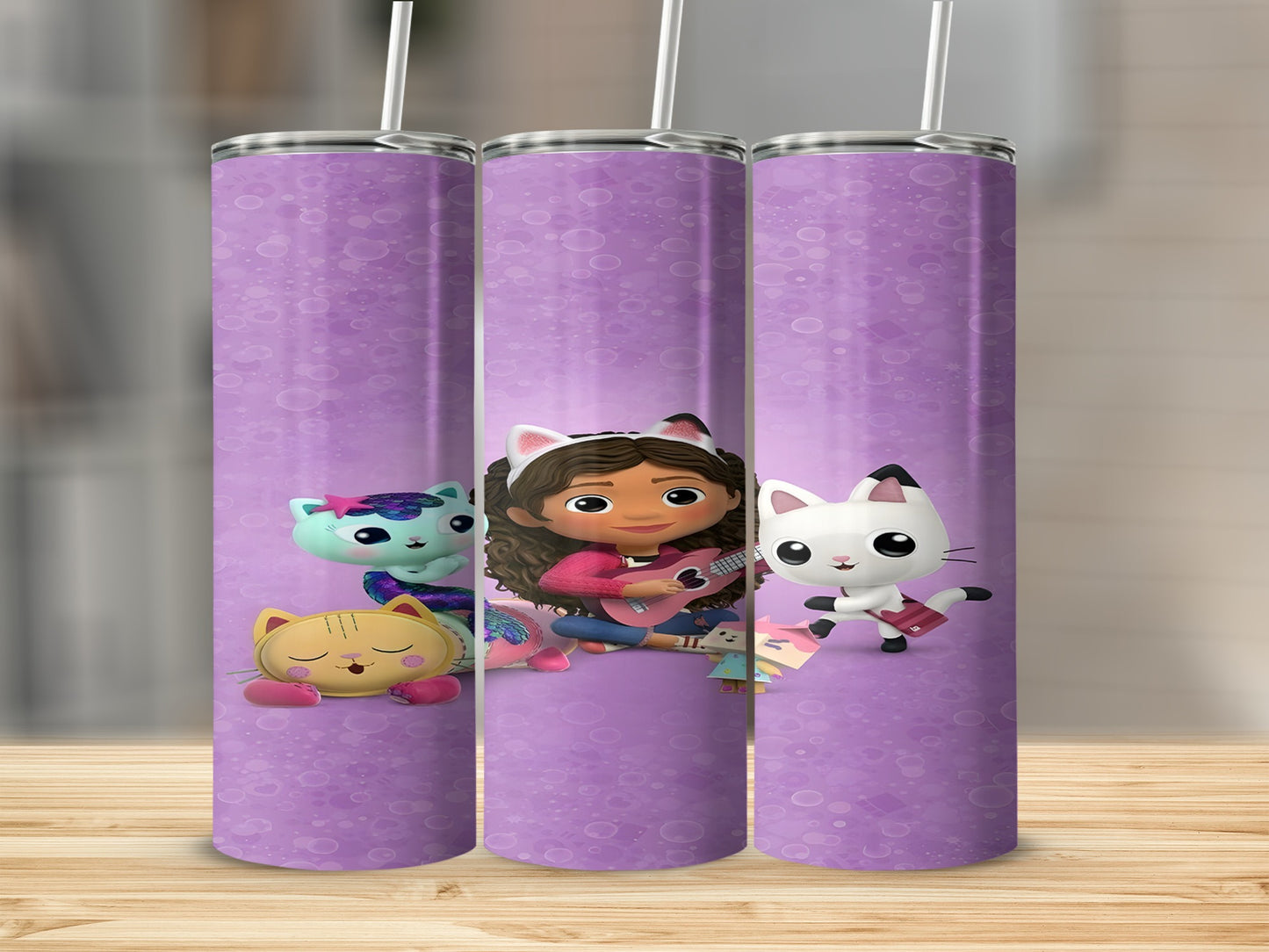 Gabby's Dollhouse characters on a purple patterned tumbler.