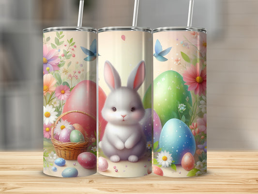 Easter bunny, colorful eggs, and flowers on three skinny tumblers.