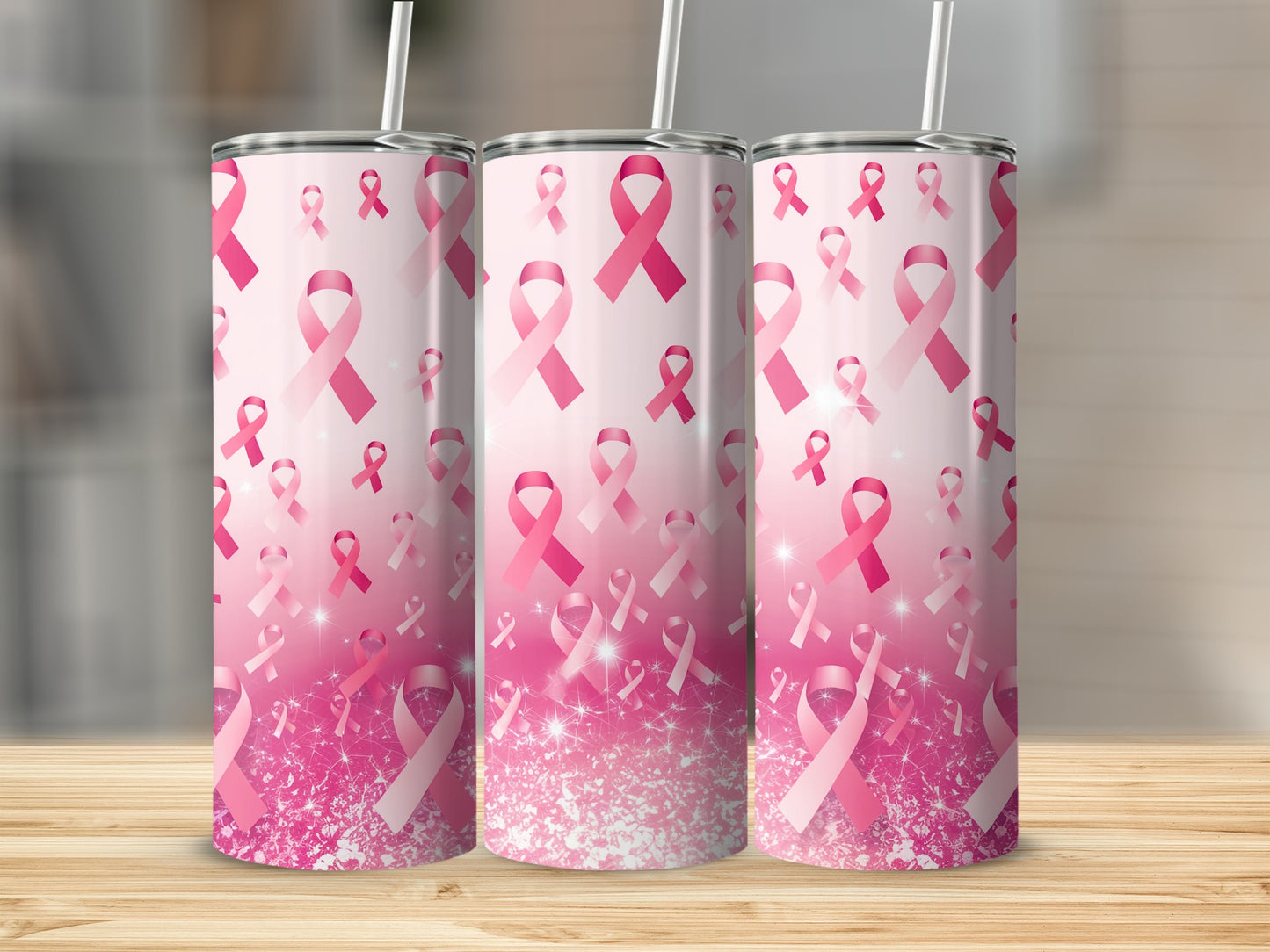 Three pink breast cancer awareness ribbon tumblers with glitter accents.