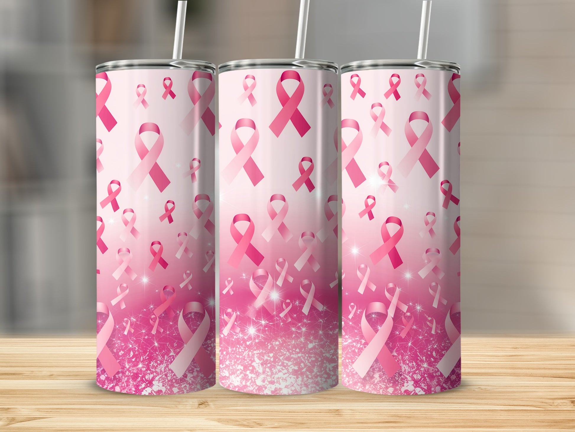 Three pink breast cancer awareness ribbon tumblers with glitter accents.