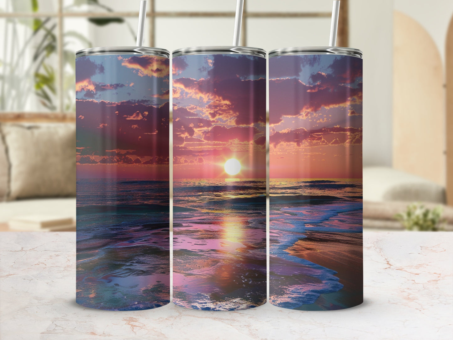Three tumblers with a vibrant sunset beach scene wrap around them.