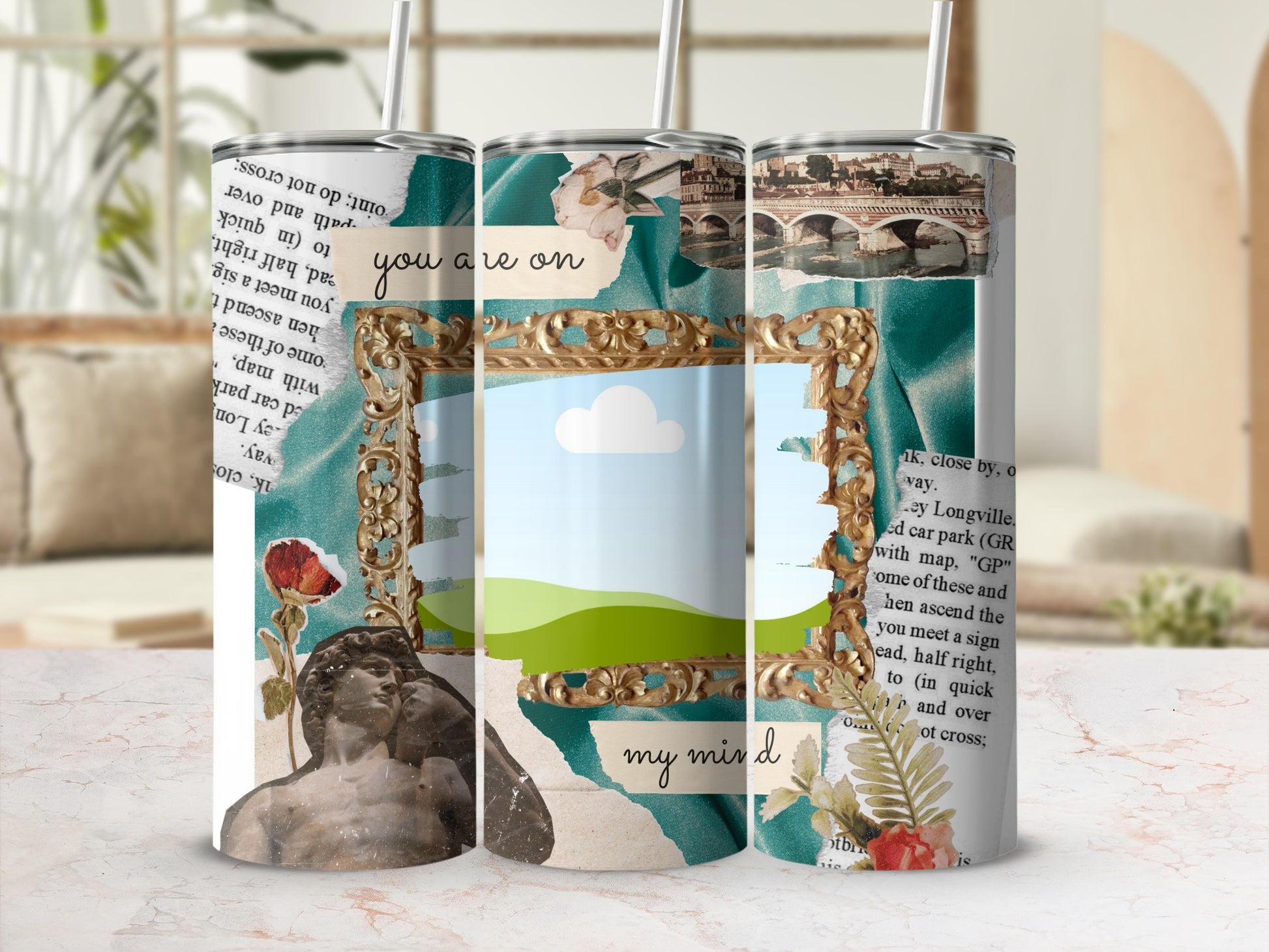 Collage art tumbler with a classical statue, bridge, text, and floral elements.