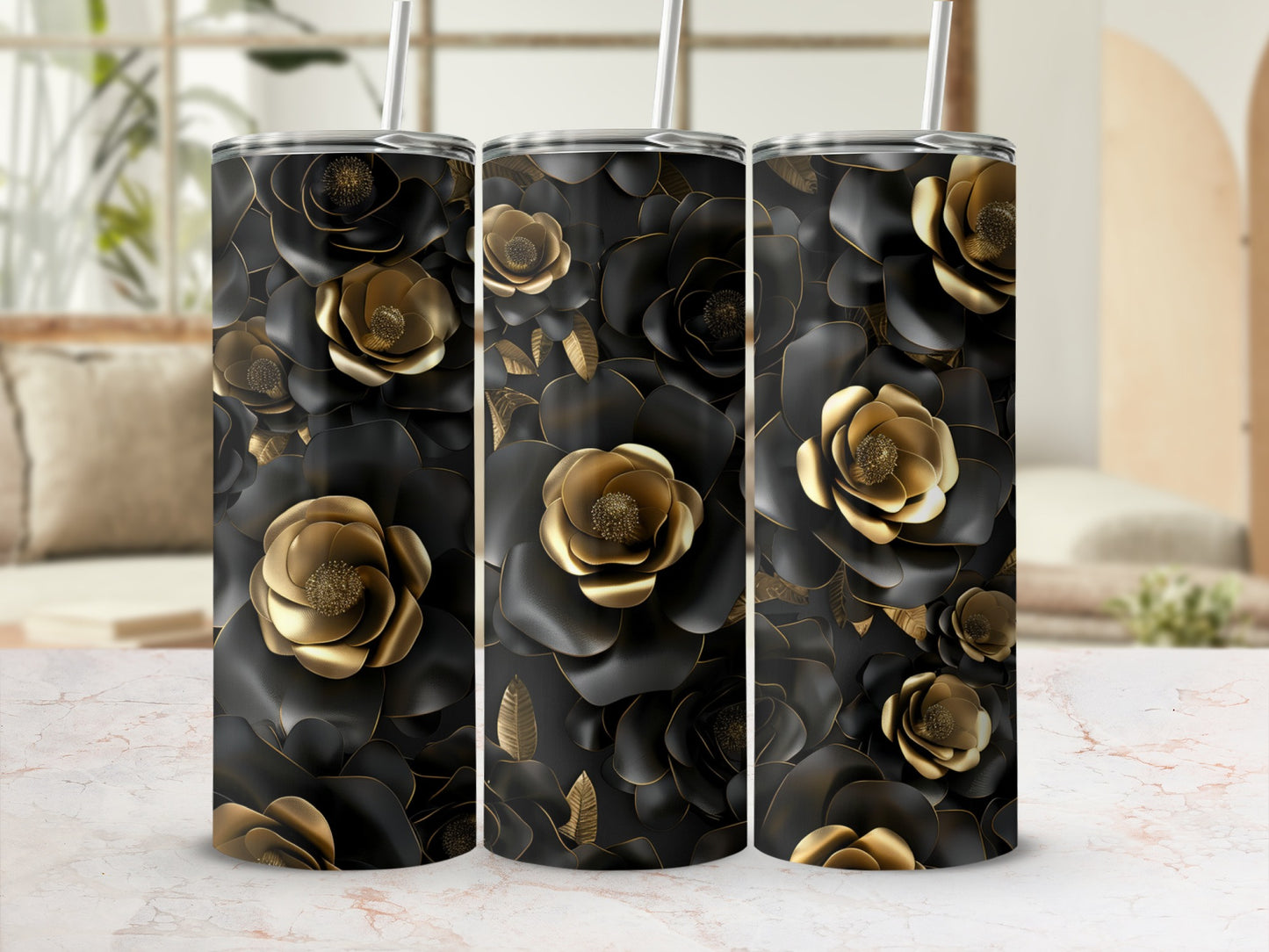 Black and gold floral tumblers with straws on a marble surface.