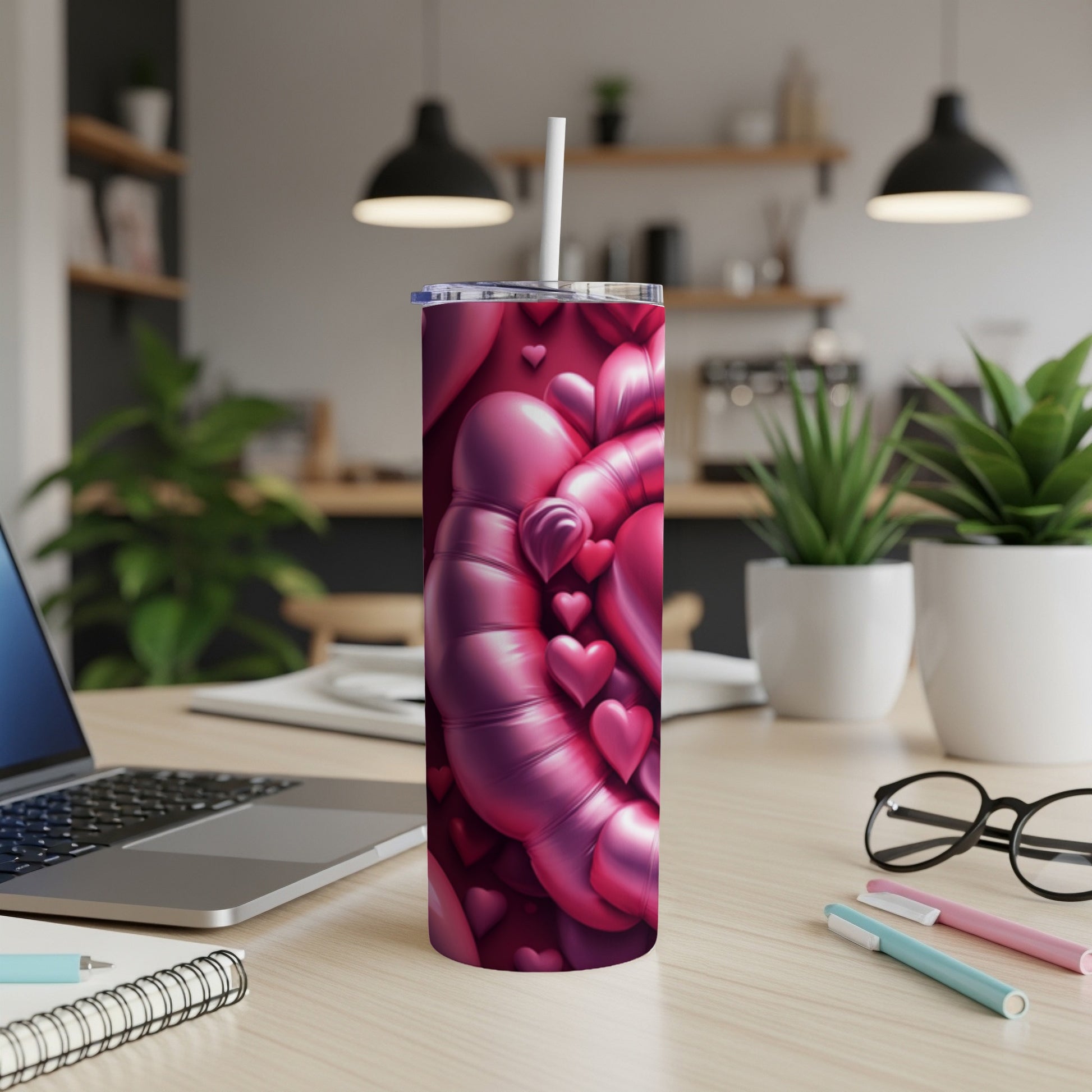 Pink and purple heart pattern on a tall tumbler with a straw.