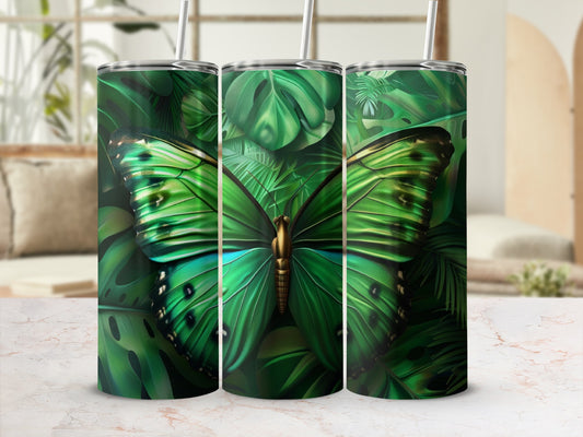 Green butterfly and tropical leaves on three tumblers with straws.