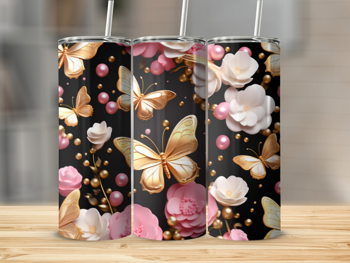 Three tumblers with golden butterflies and pink flowers on a black background.
