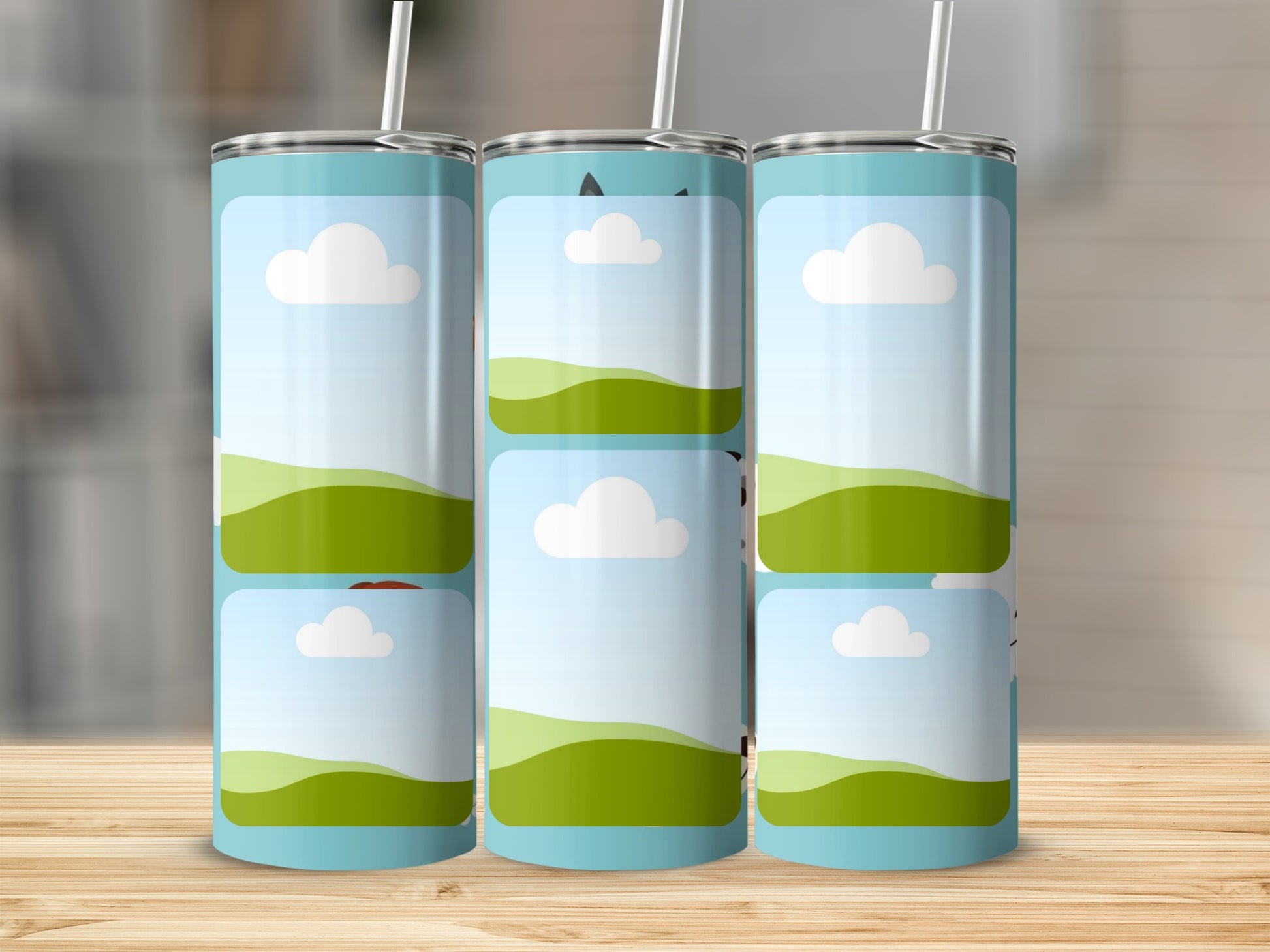 Three tumblers with a cartoon landscape design and white straws.