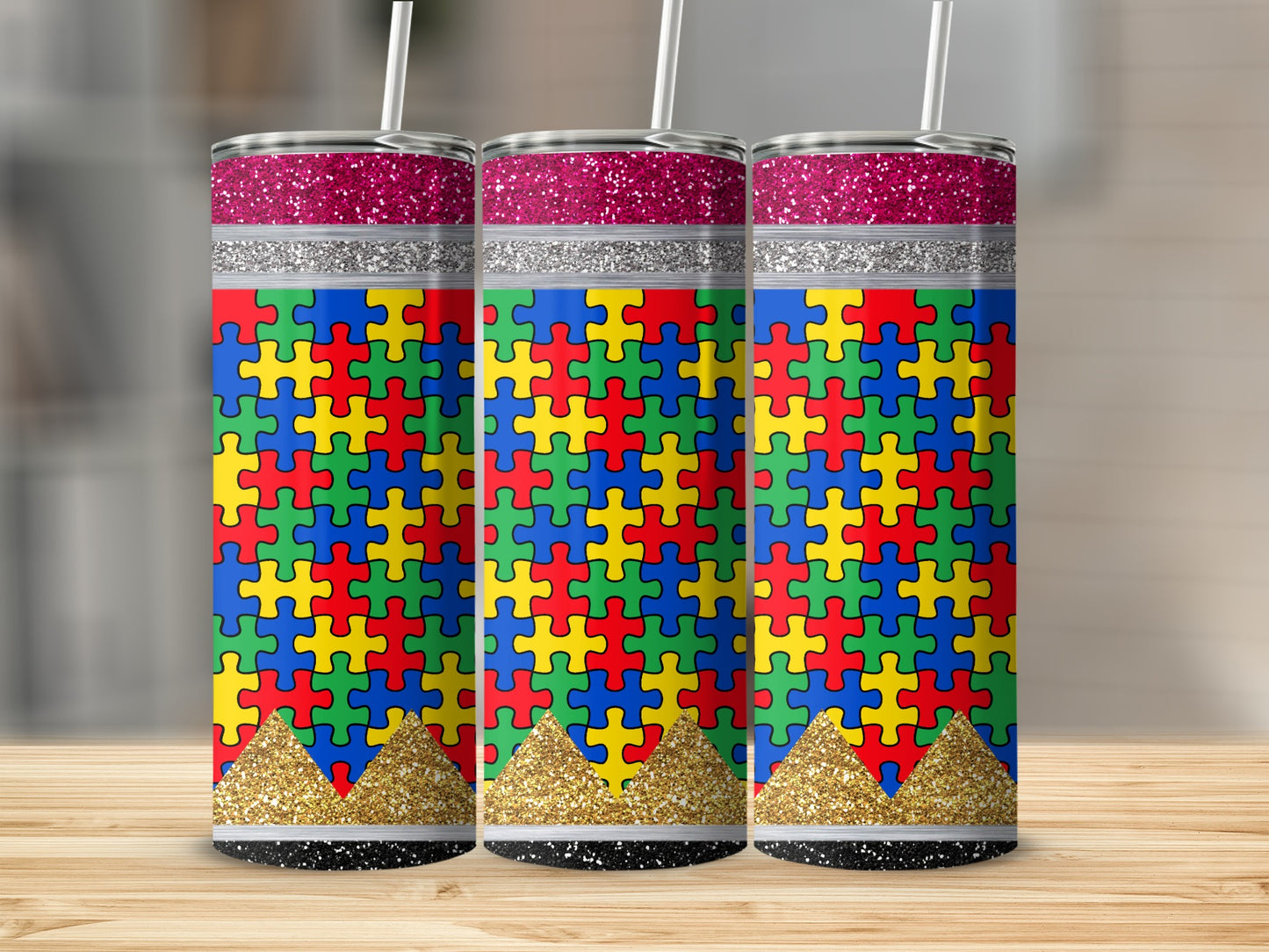 Three tumblers with autism puzzle piece designs and glitter accents.