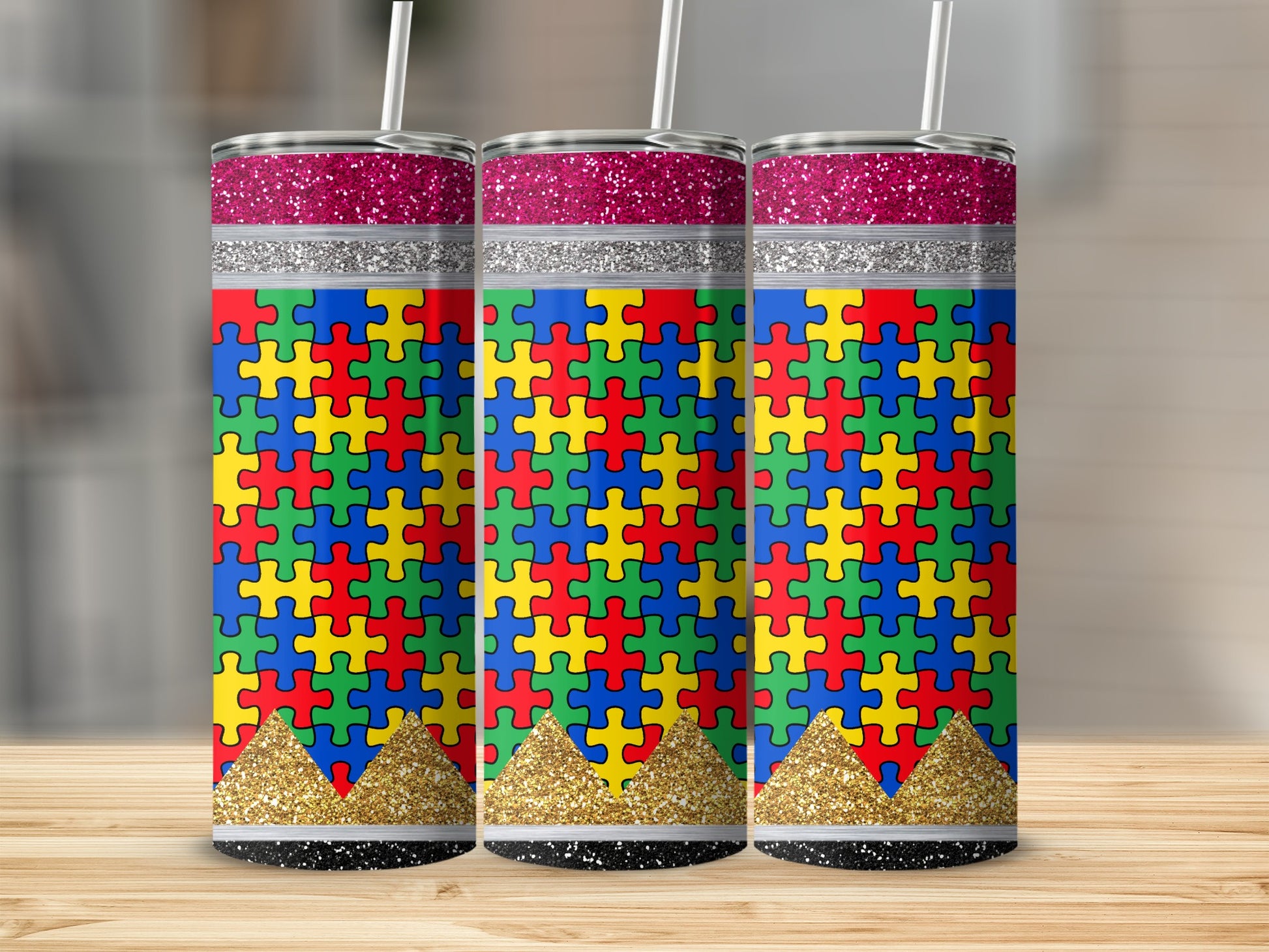 Three tumblers with autism puzzle piece designs and glitter accents.