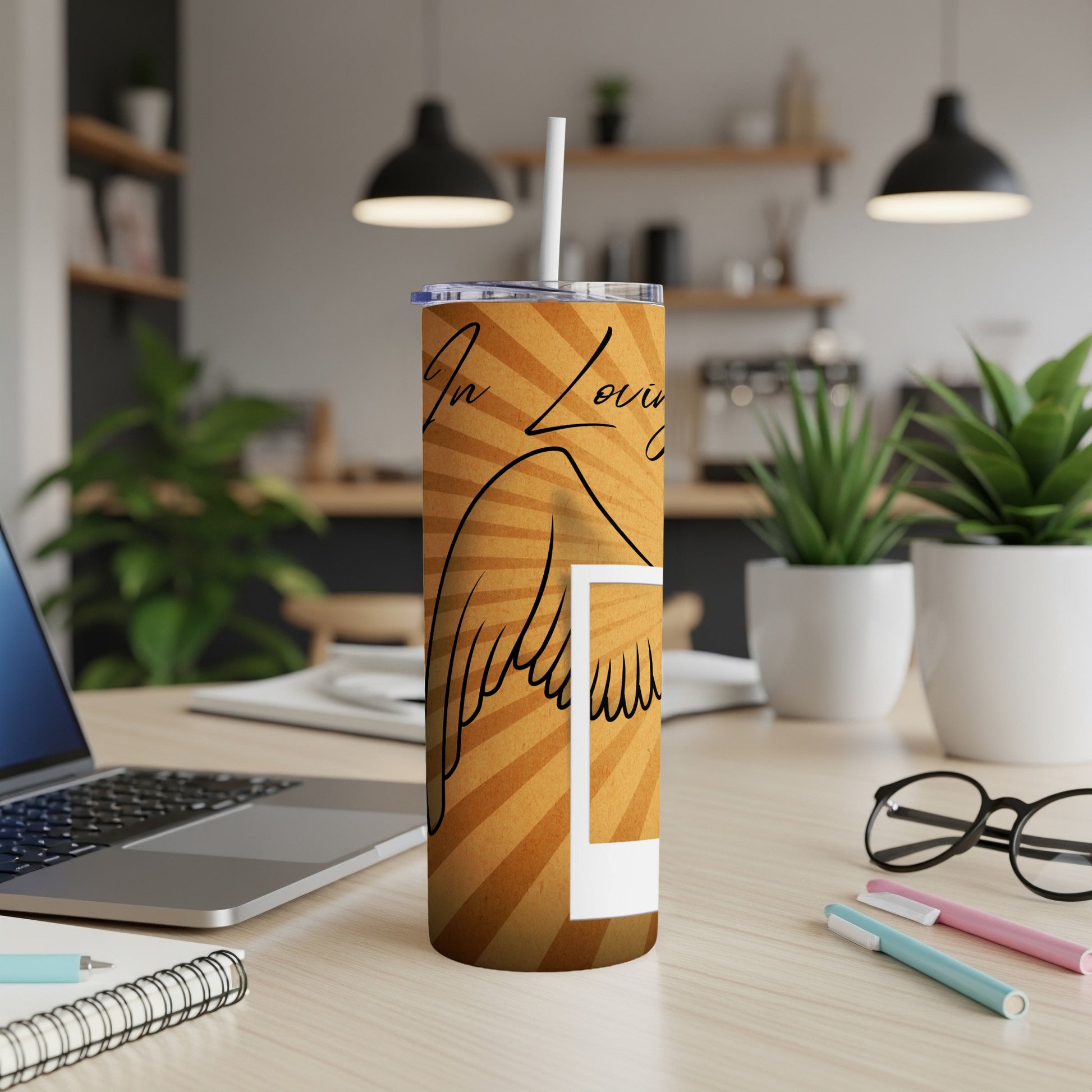 Tumbler with angel wings and text "In Loving Memory" on a sunburst background.