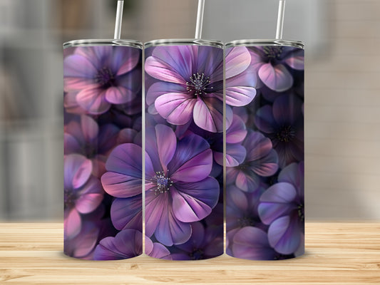 Three purple floral tumblers with straws on a wooden surface.