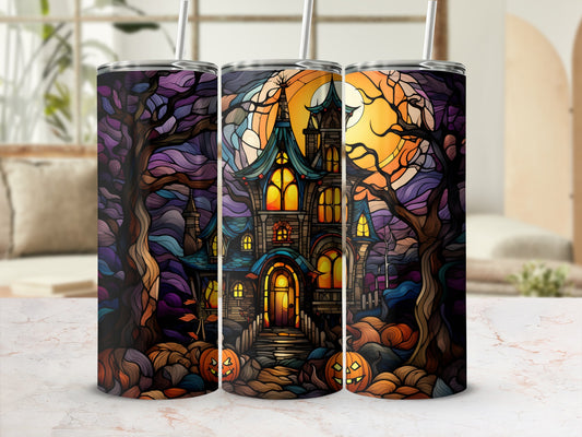 Spooky haunted house with pumpkins and moon on a colorful tumbler.