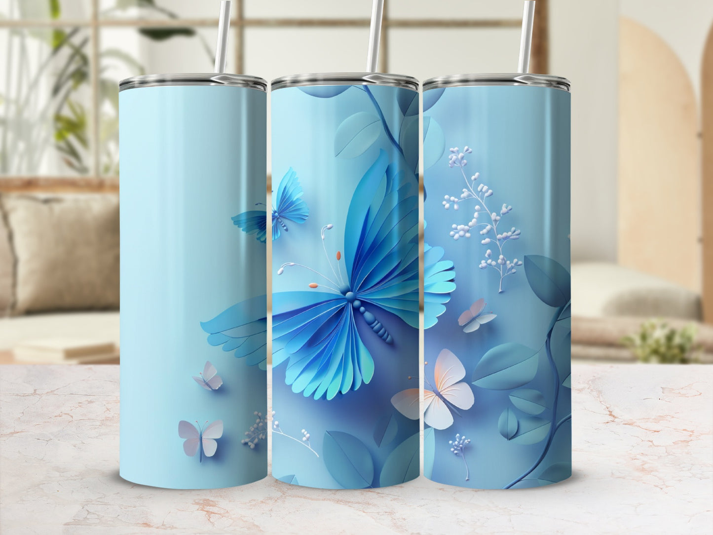 Blue tumbler with butterflies and floral accents on a light background.