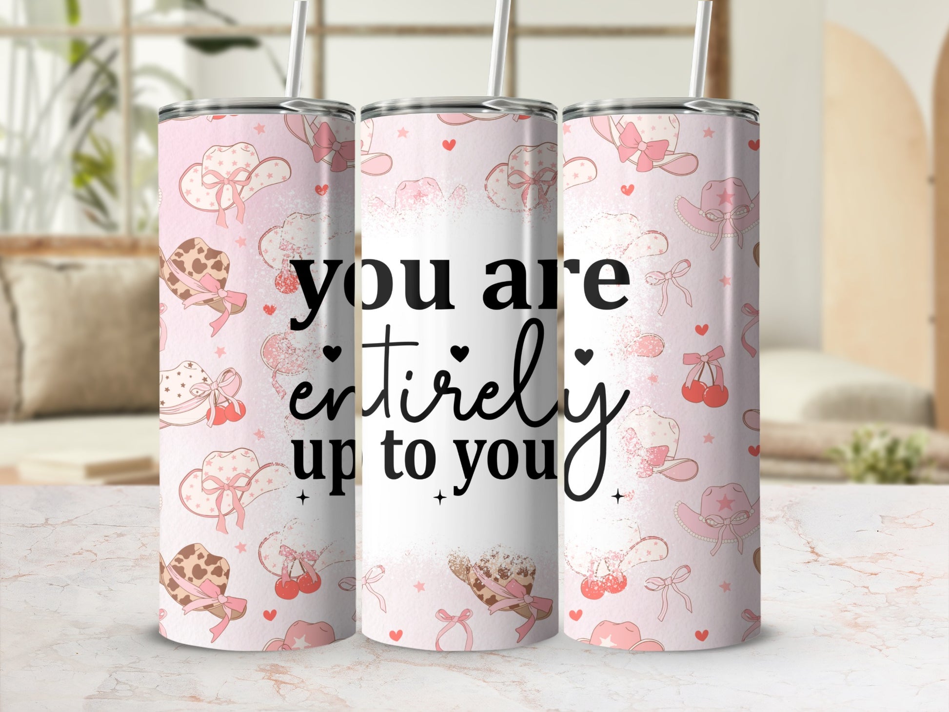 Pink cowgirl tumbler with hats, cherries, and text "you are entirely up to you".
