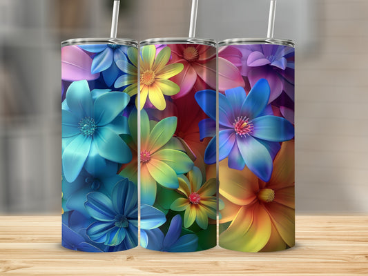 Three colorful floral tumblers with straws displayed on a wooden surface.