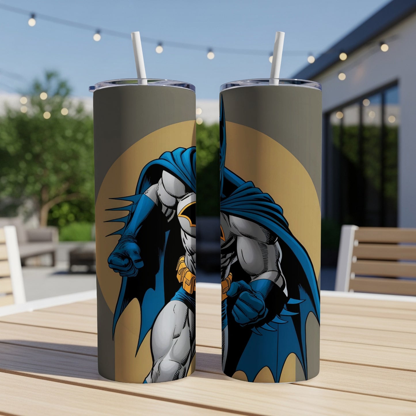 Batman illustration on two matching tumblers with straws on a table.