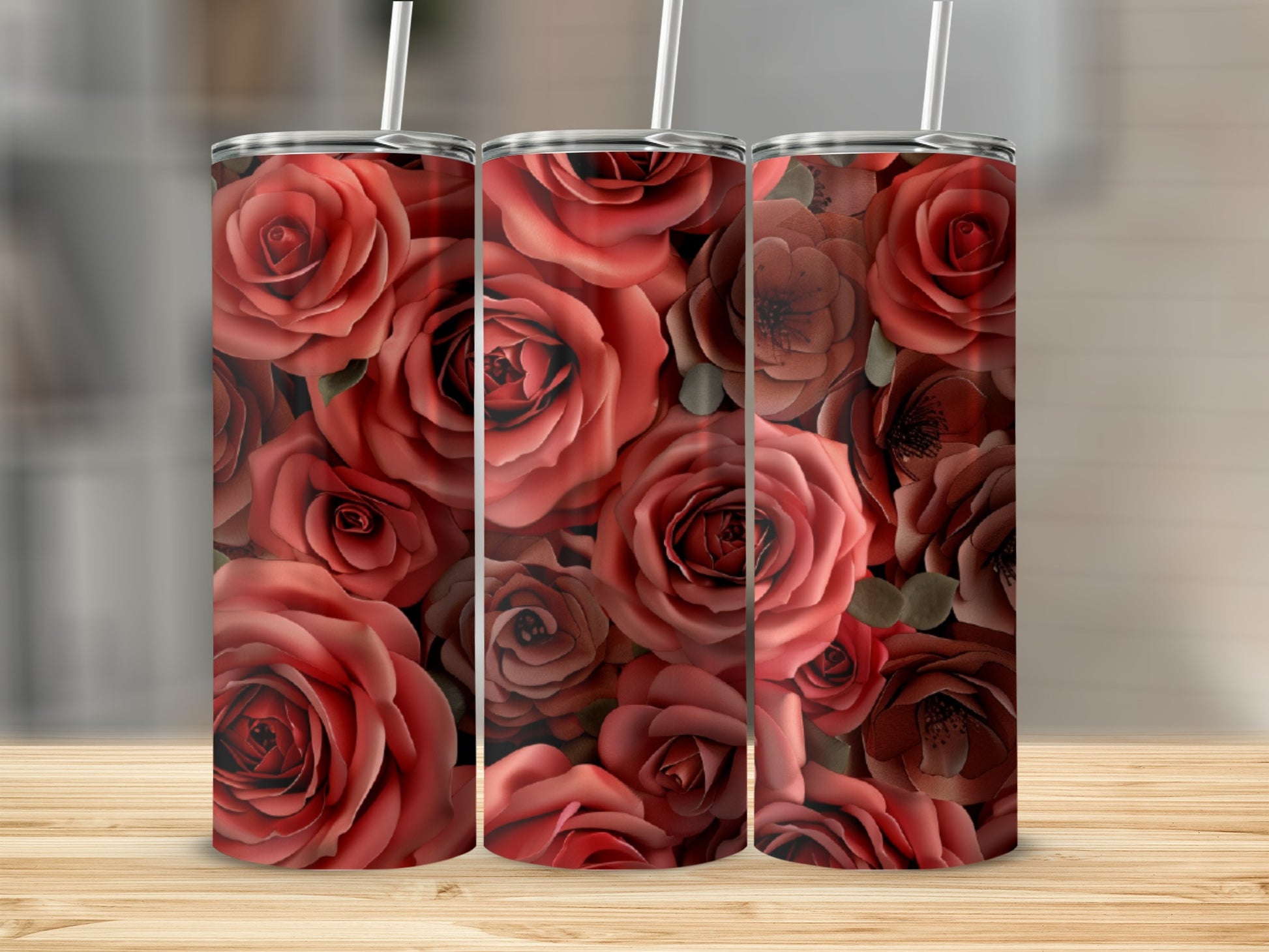Three tumblers with a dense floral pattern of red and pink roses.