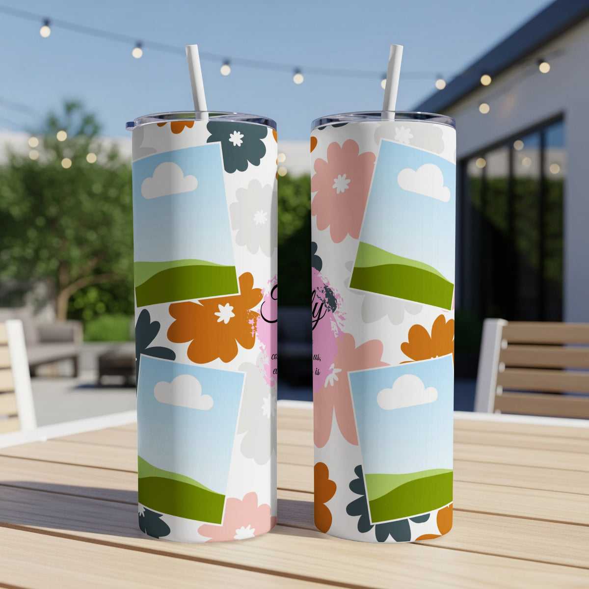 Two tumblers with a pastel floral and sky design and personalized text.