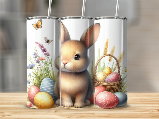 Easter bunny with colorful eggs and flowers on a patterned tumbler.