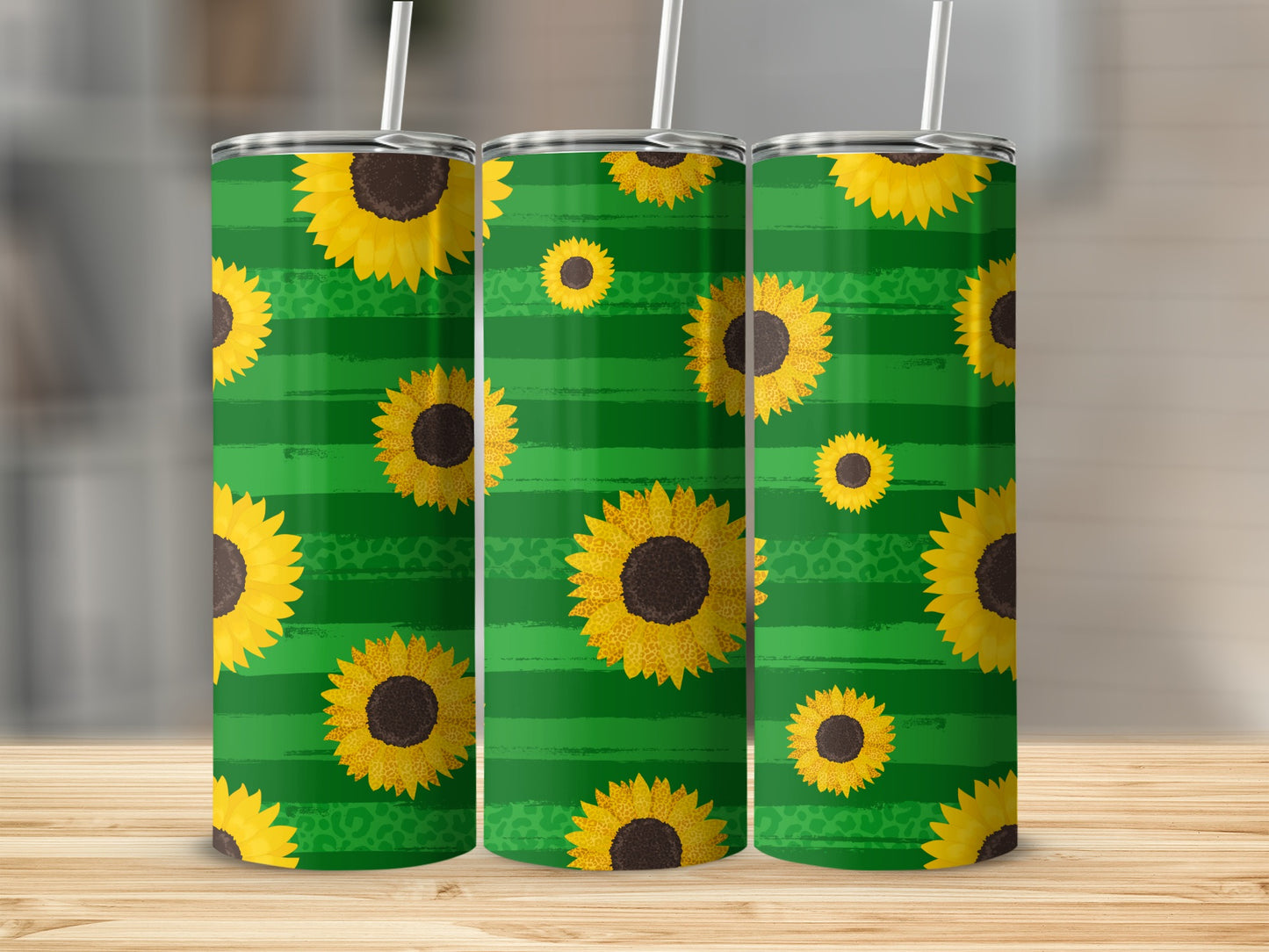 Three tall tumblers with a green striped and sunflower pattern.