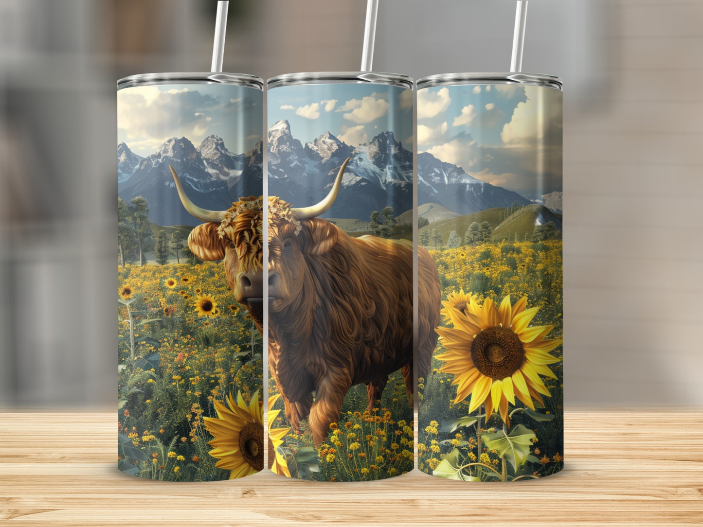 Highland cow and sunflowers in a mountain landscape on three tumblers.