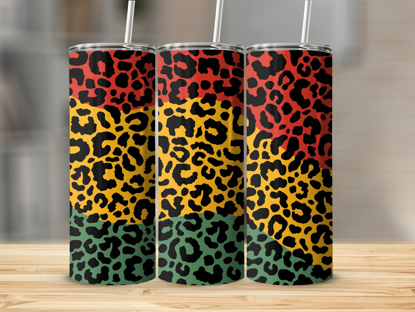 Three tumblers with red, yellow, and green leopard print patterns.