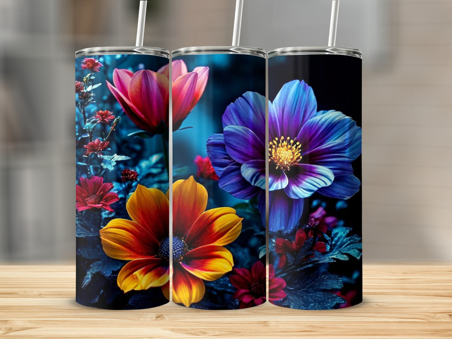 Three tumblers with vibrant floral designs of red, orange, and blue flowers.