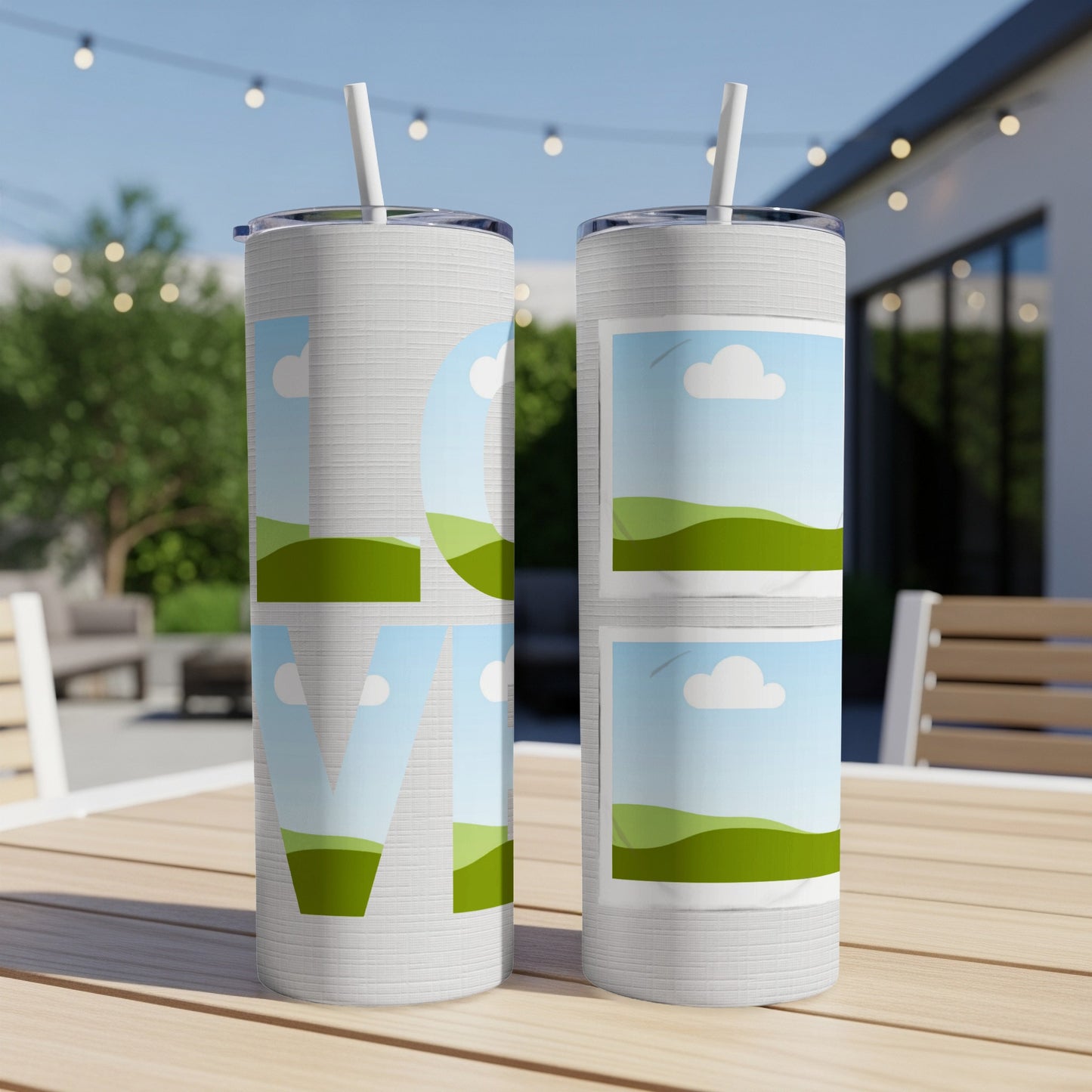 Two tumblers with "LOVE" text and landscape images on a wooden table.