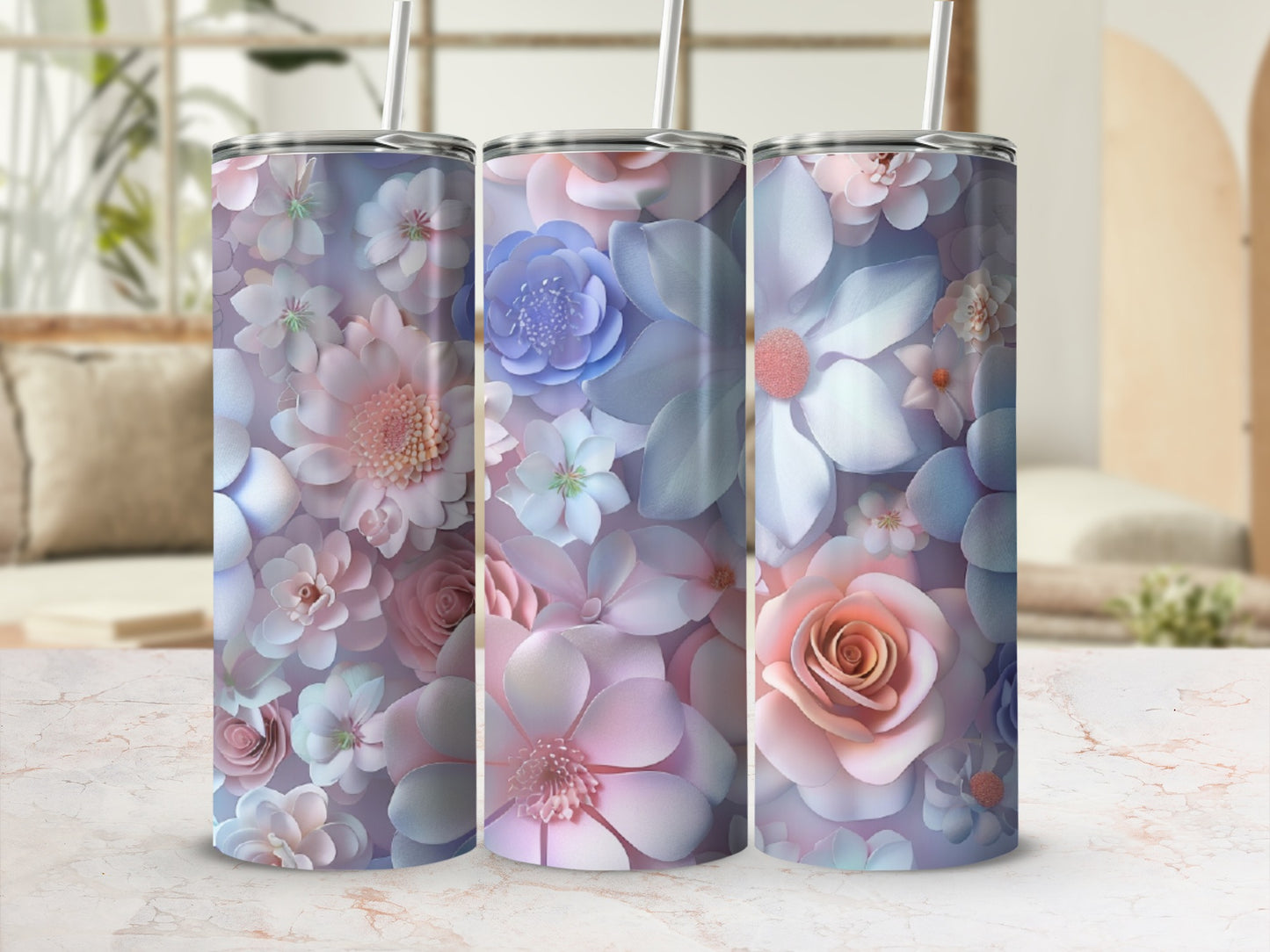 Three floral pattern tumblers with straws in soft pastel colors.