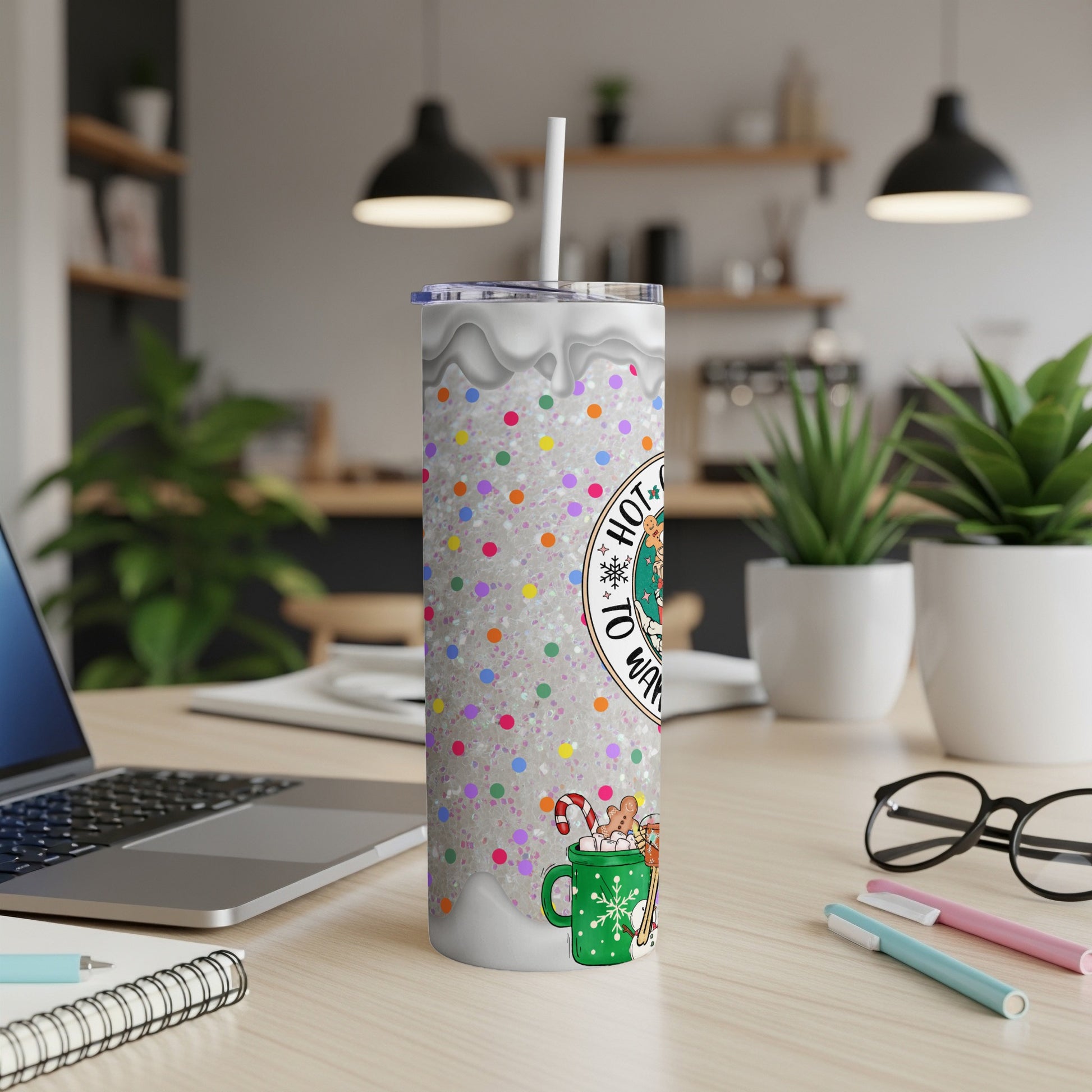 Glittery Christmas tumbler with "Hot Cocoa" text, candy cane, and festive mugs.