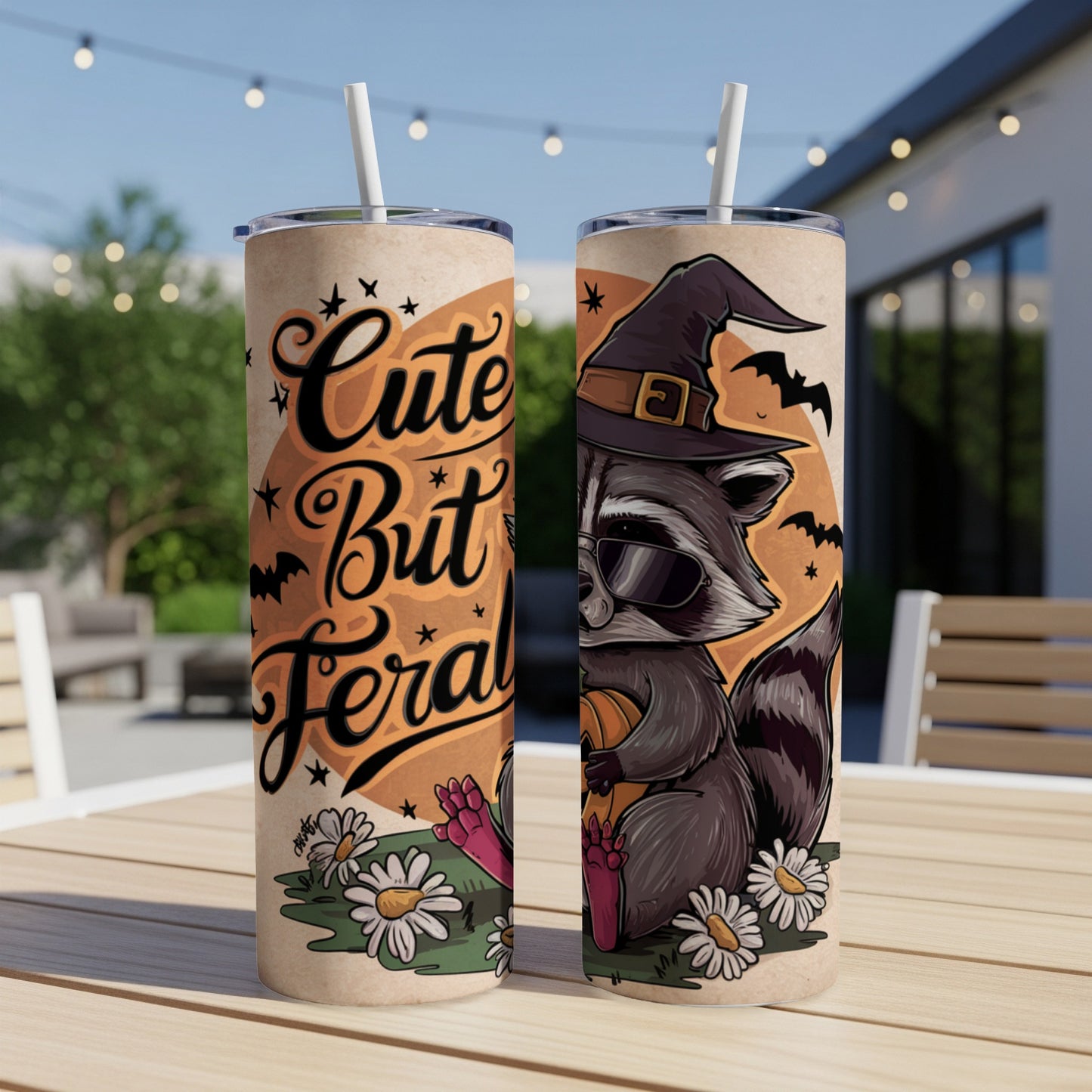 Tumbler with raccoon in witch hat, sunglasses, holding pumpkin, text "Cute But Feral".