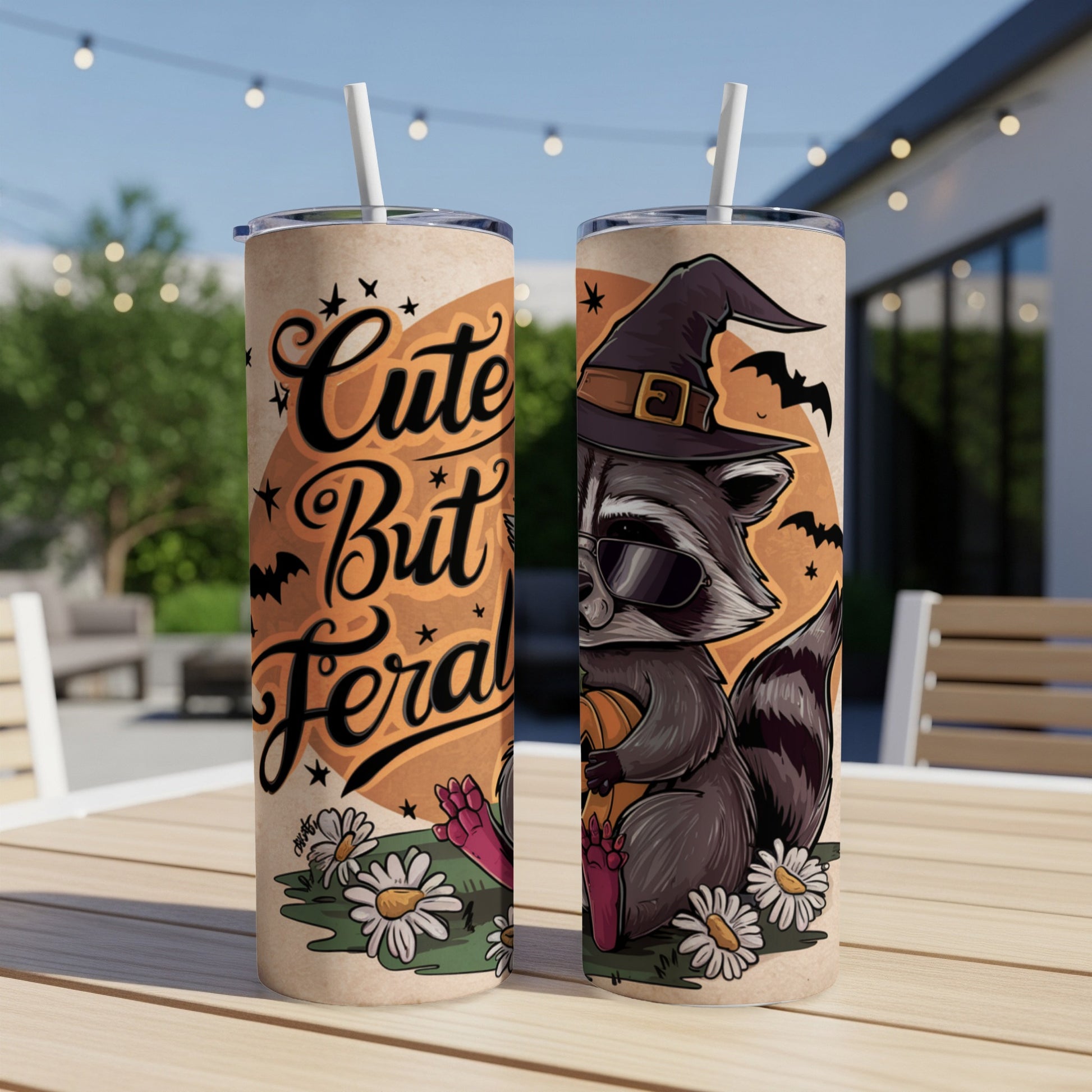 Tumbler with raccoon in witch hat, sunglasses, holding pumpkin, text "Cute But Feral".