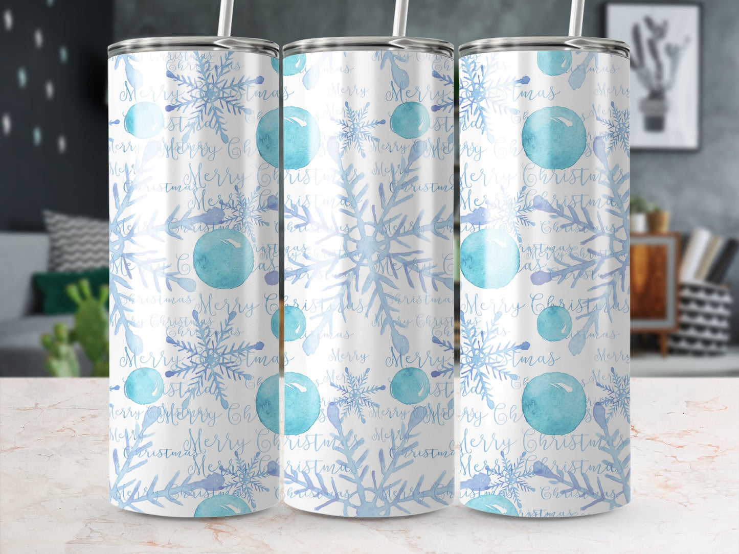 Three tumblers with a blue snowflake and "Merry Christmas" pattern on a marbled surface.