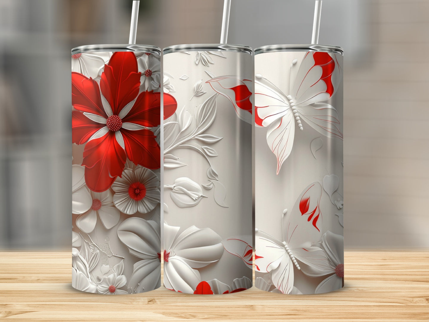 Three white tumblers with embossed red butterflies and floral designs.
