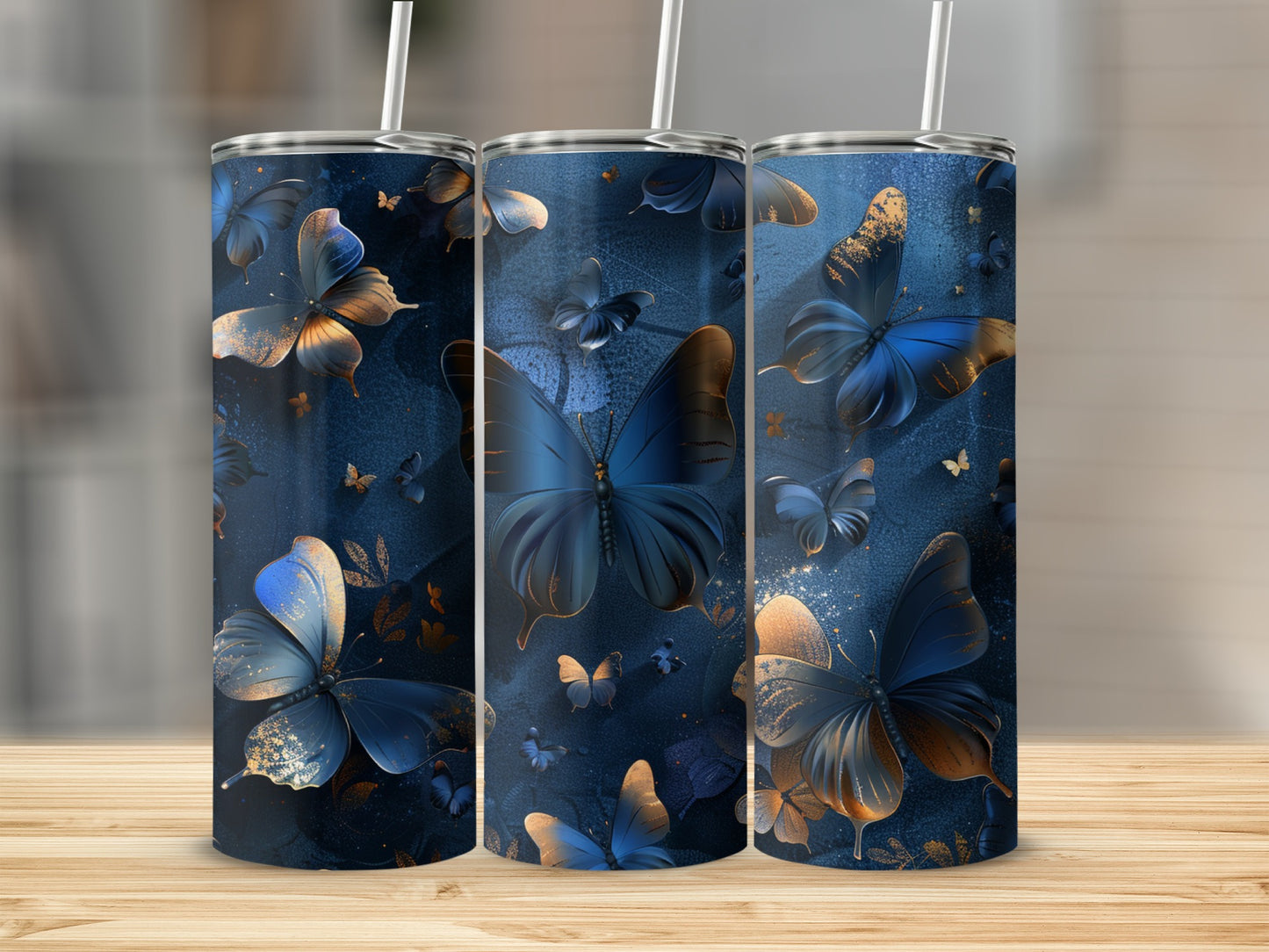 Three tumblers with navy blue background and gold and blue butterflies.