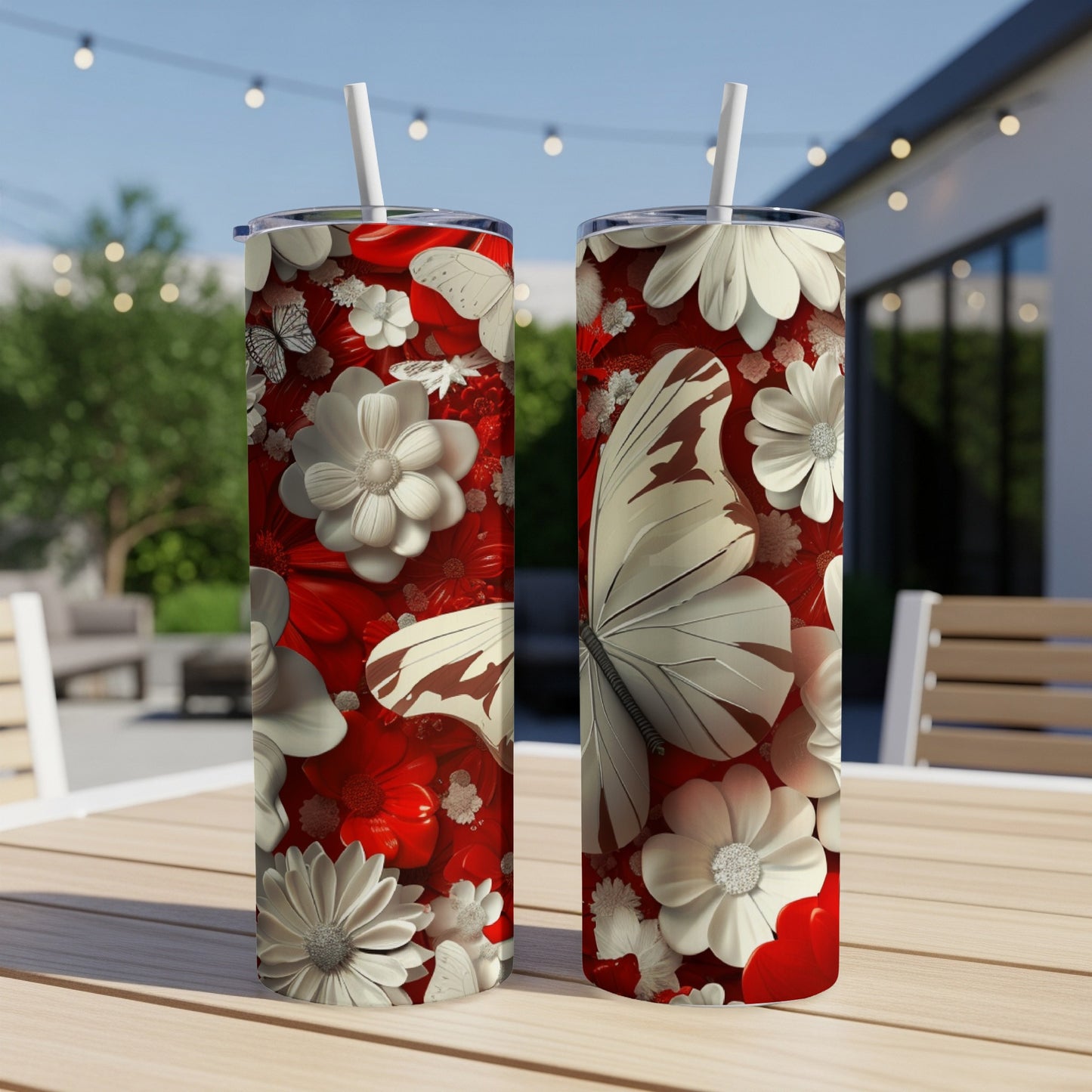 Two tall tumblers with red and white floral and butterfly designs.