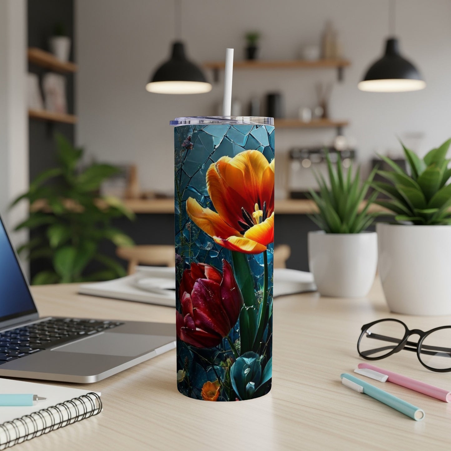 Tall tumbler with vibrant red and orange tulips on a dark background.