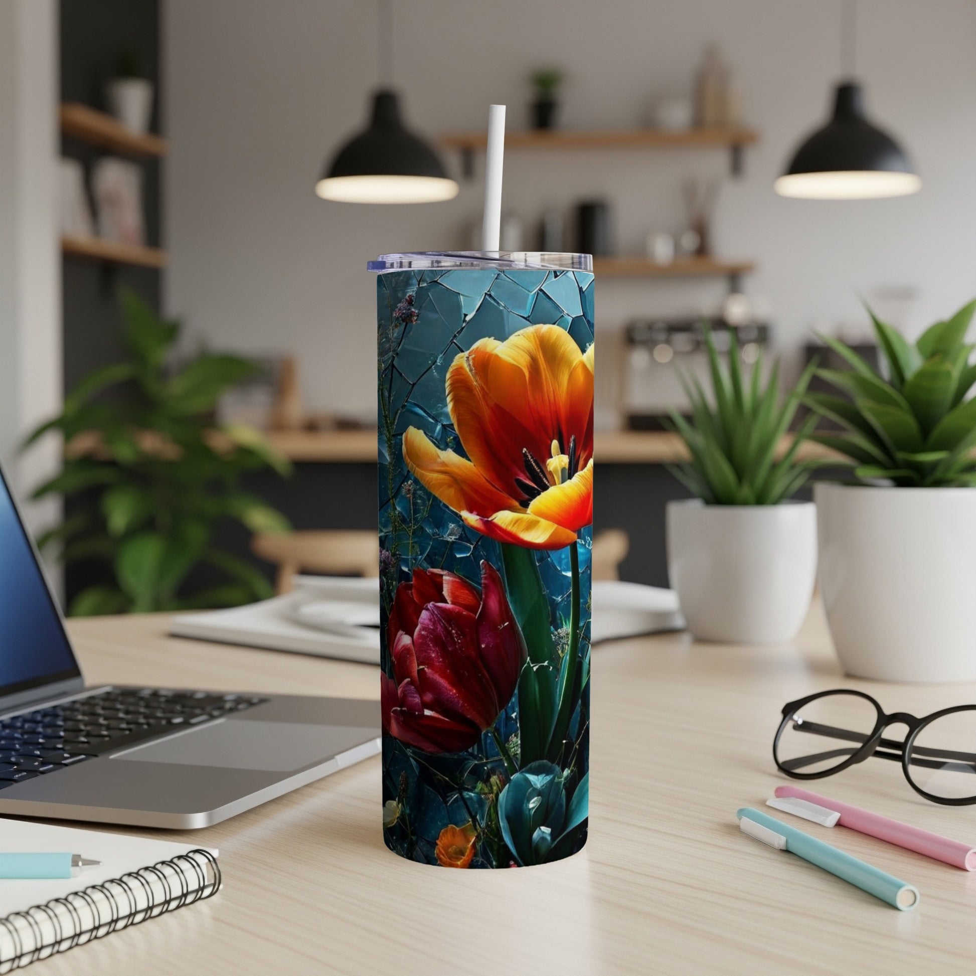 Tall tumbler with vibrant red and orange tulips on a dark background.