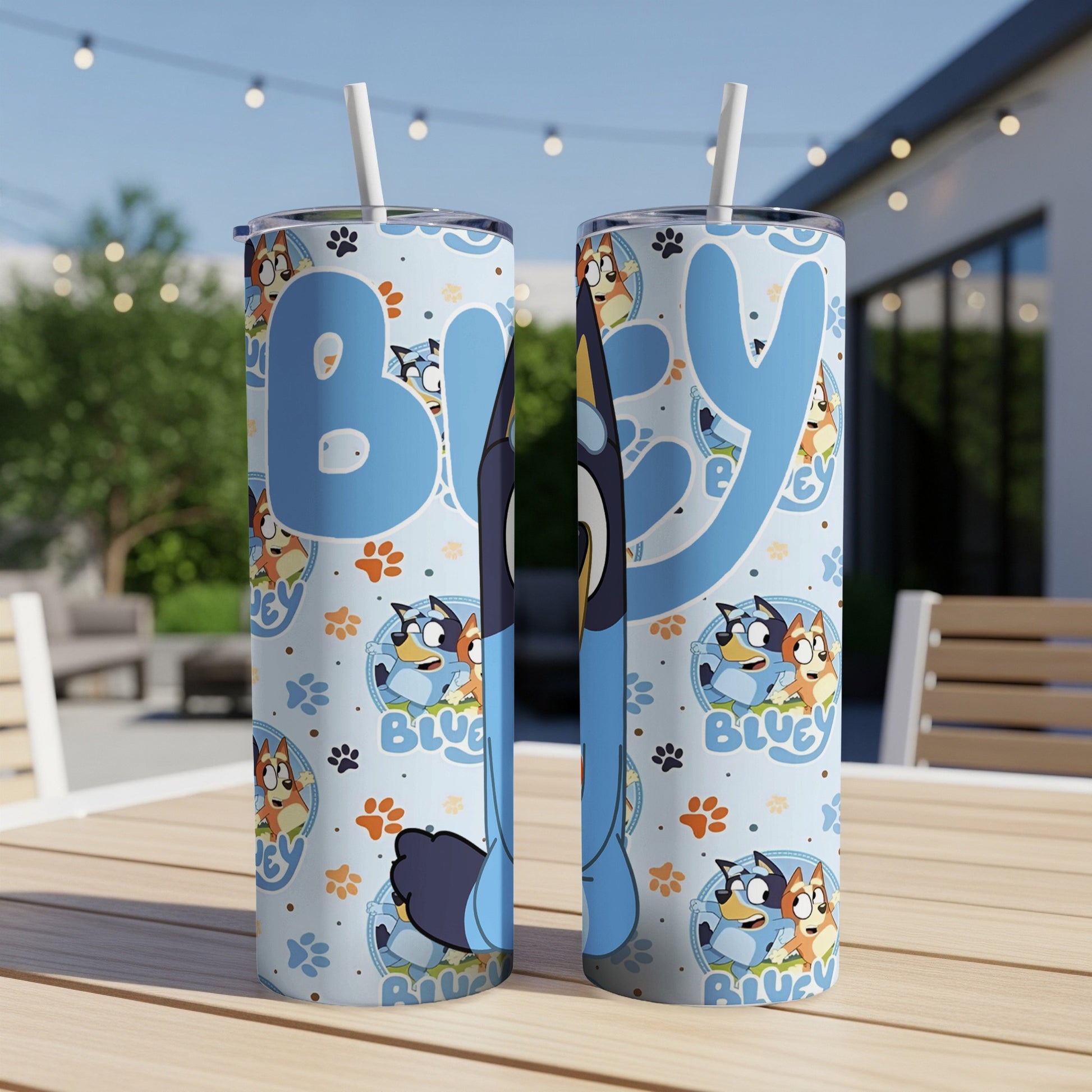 Bluey character pattern on two insulated tumblers on a wooden table.