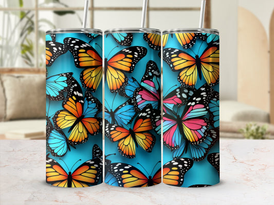 Tumbler with colorful butterfly design on blue background.