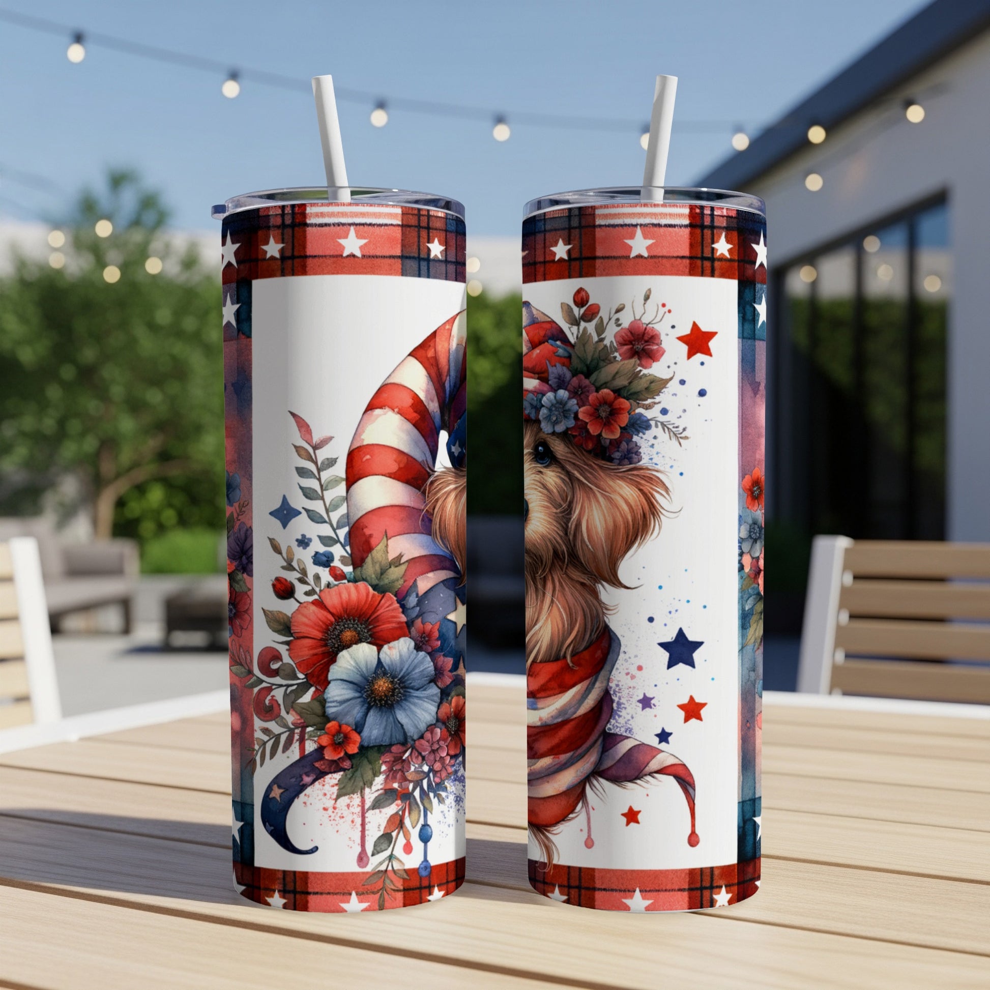 Two tumblers with patriotic dog and floral designs, placed outdoors.