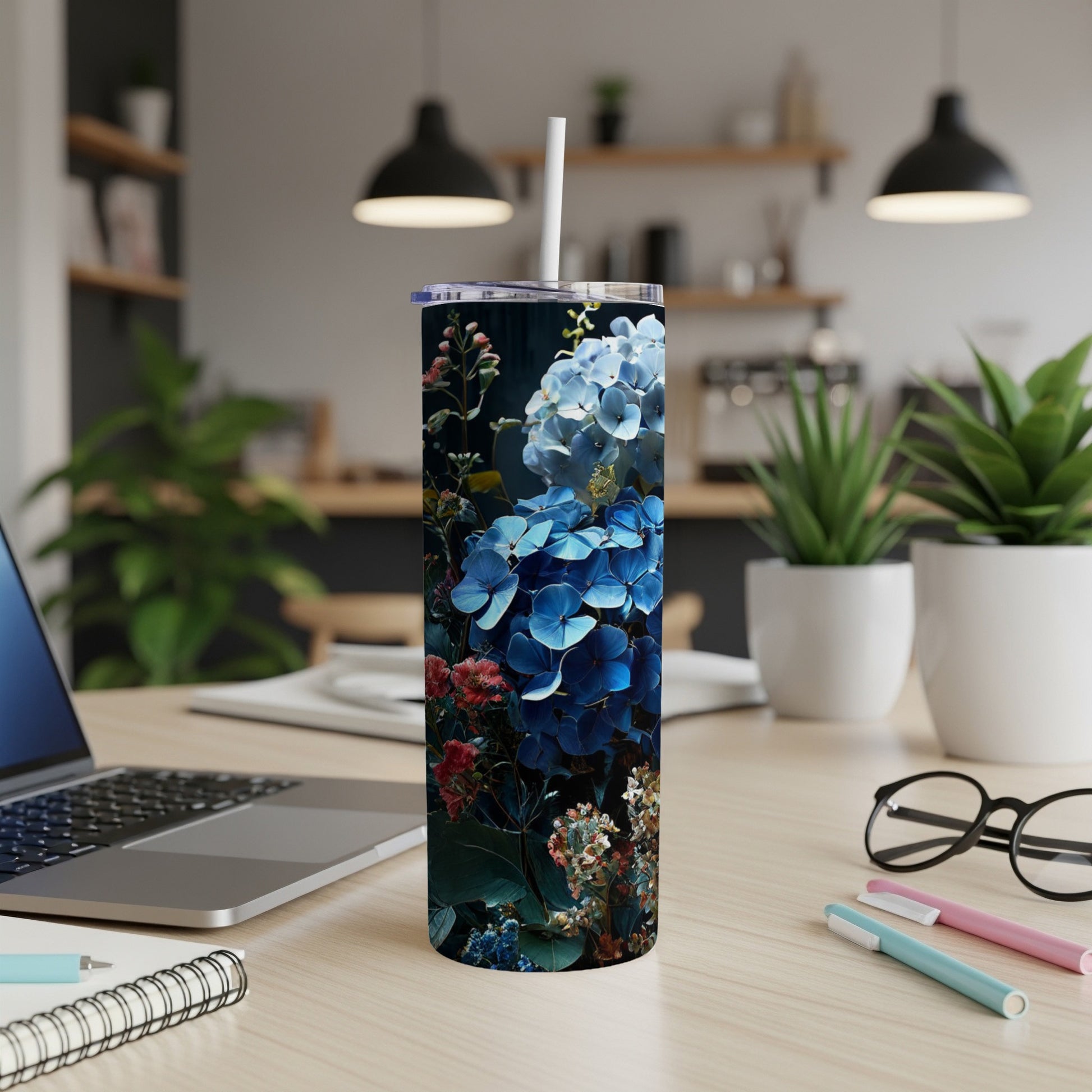 Blue hydrangea floral pattern on a tall tumbler with a straw.